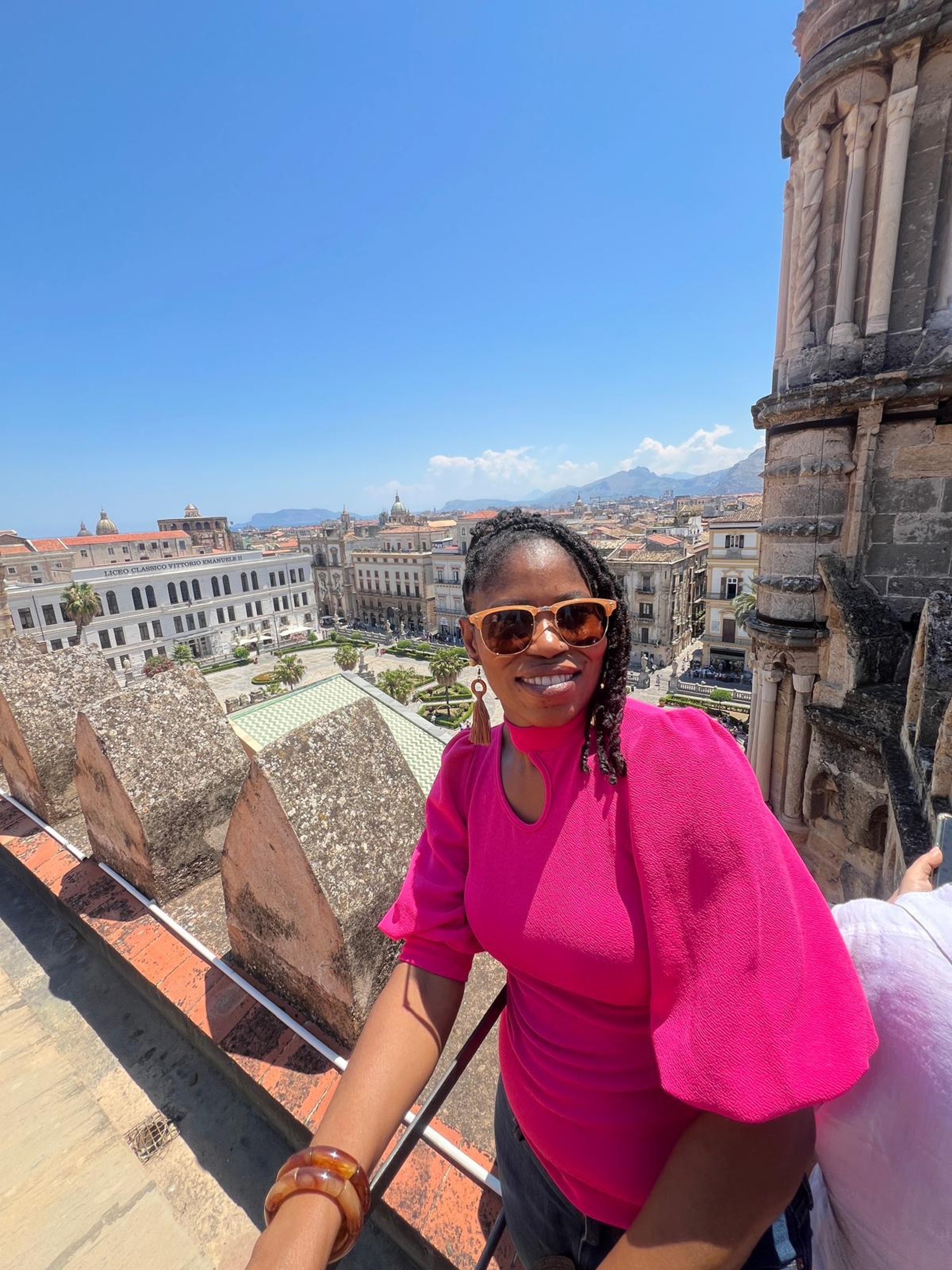an abstract photo of a curved building with a blue sky in the background