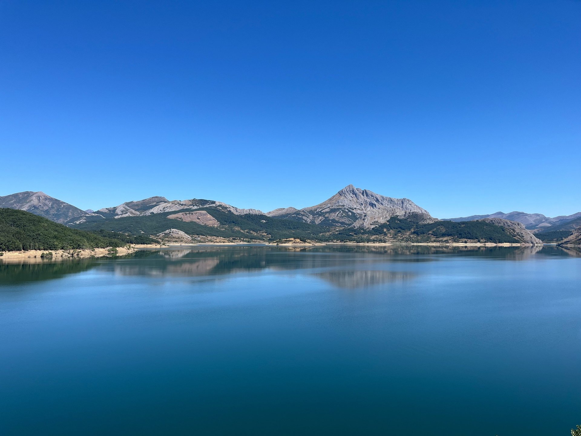 woman wearing yellow long-sleeved dress under white clouds and blue sky during daytime
