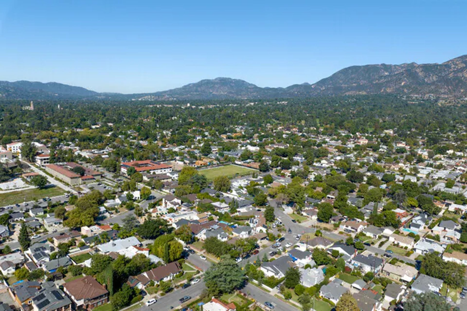 an abstract photo of a curved building with a blue sky in the background