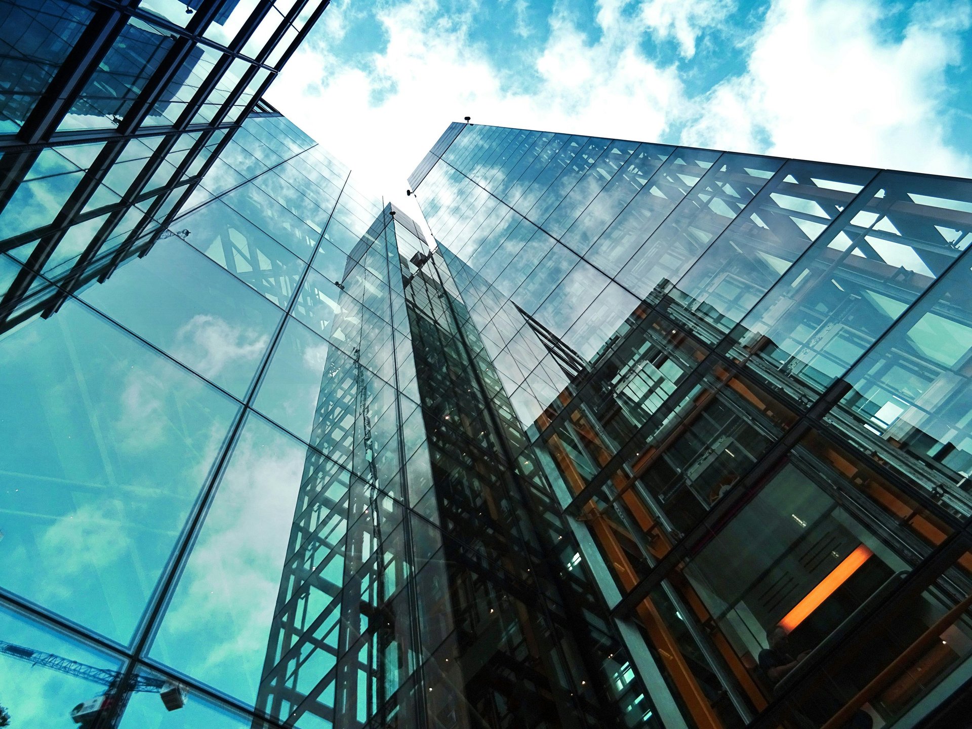 an abstract photo of a curved building with a blue sky in the background