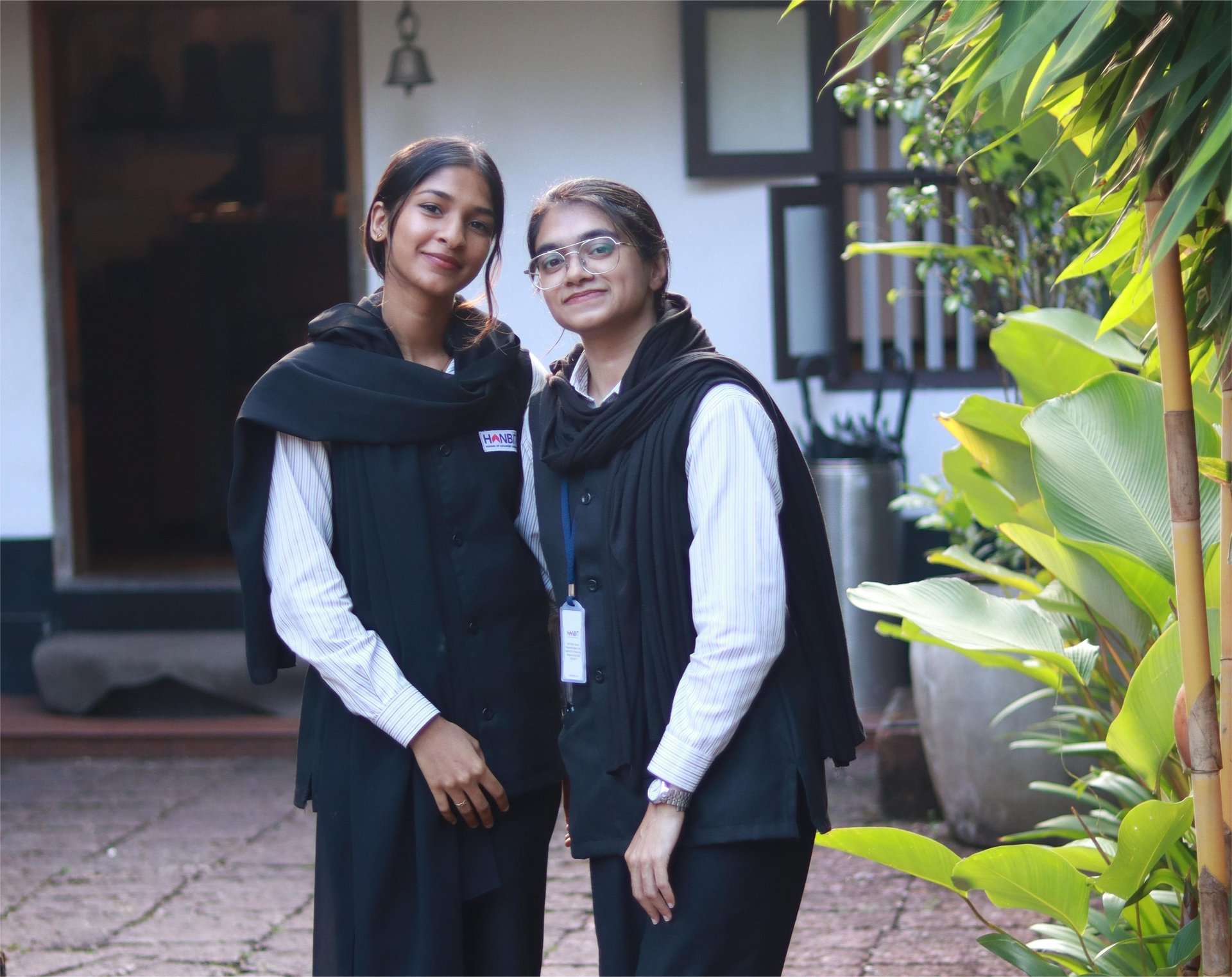woman carrying white and green textbook