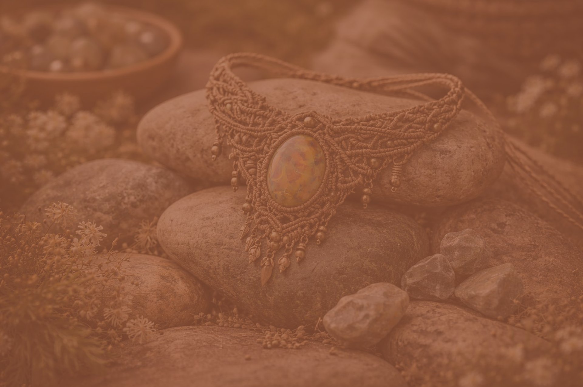 Collar de macramé hecho con piedra de tigre sobre rocas