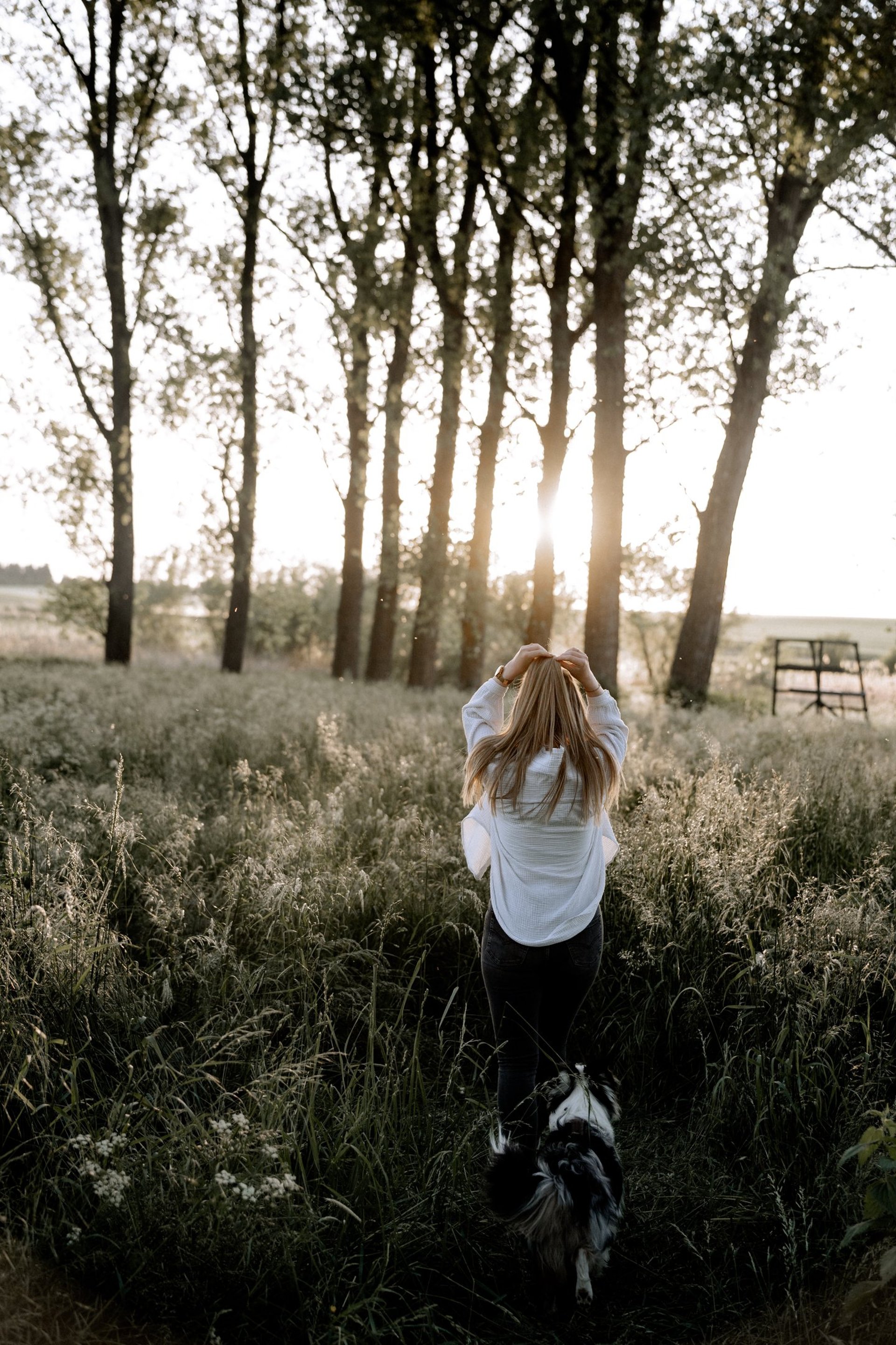 woman in black jacket standing on road during daytime