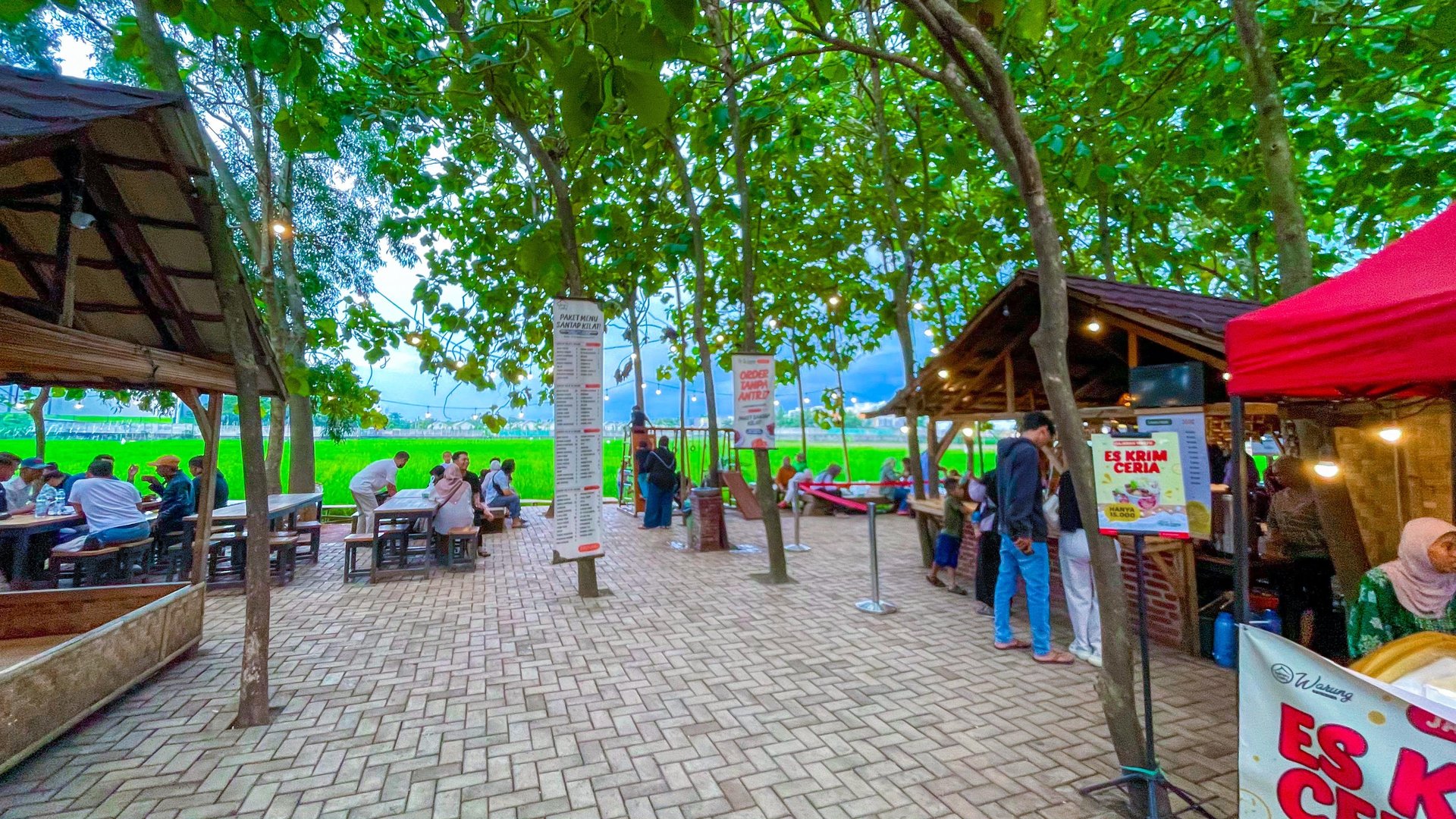 a person walking across a sandy beach next to a wave