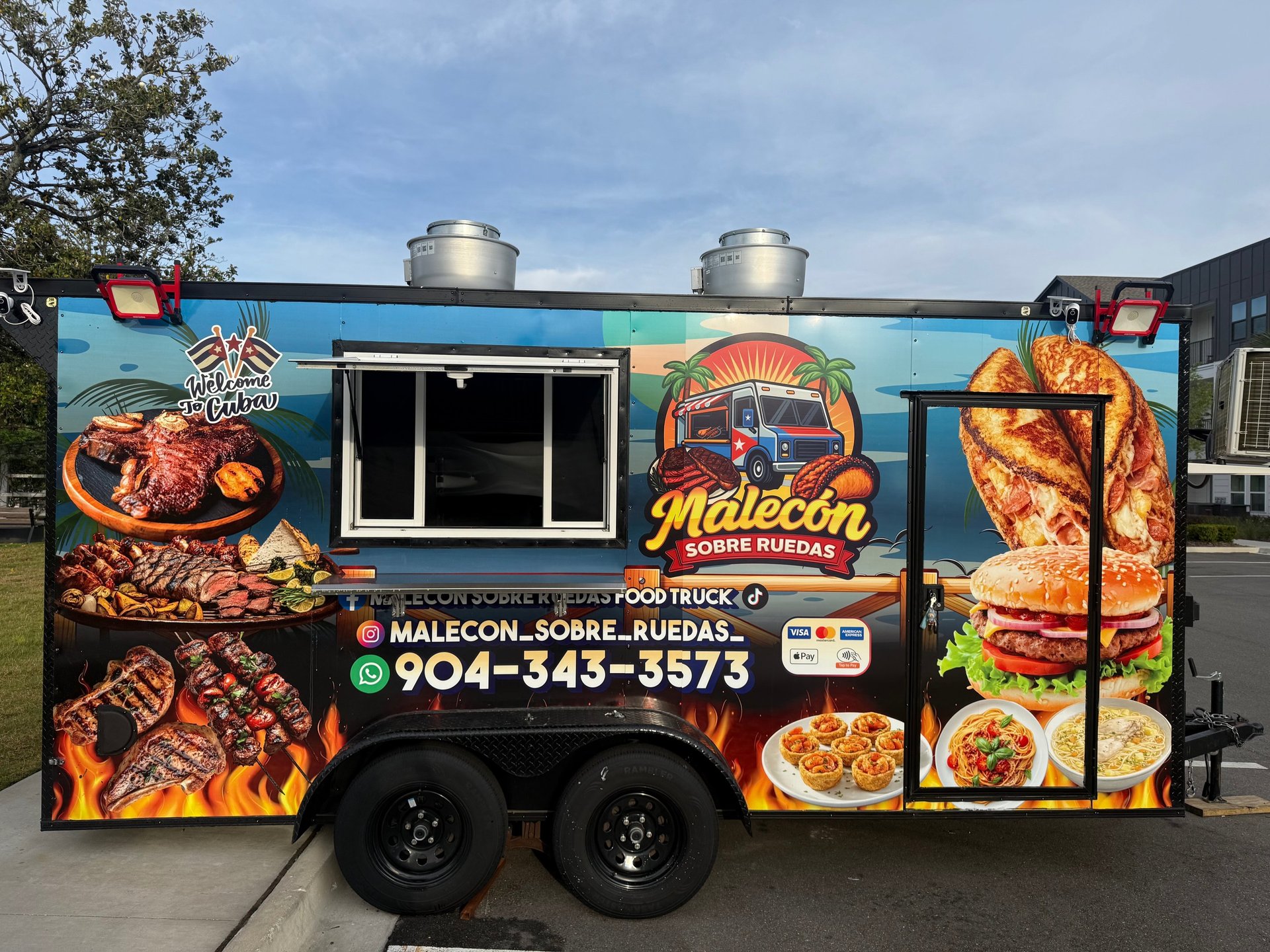 a group of people standing in front of a food truck