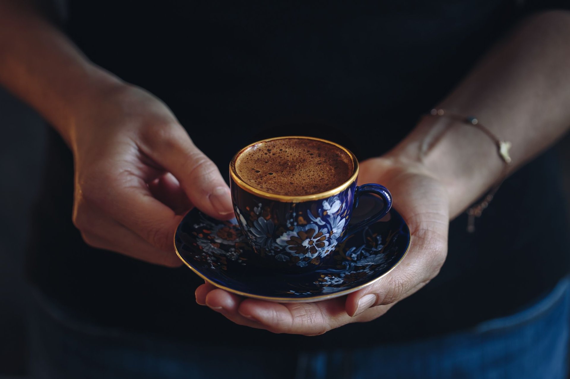 A cup of coffee sitting on top of a newspaper