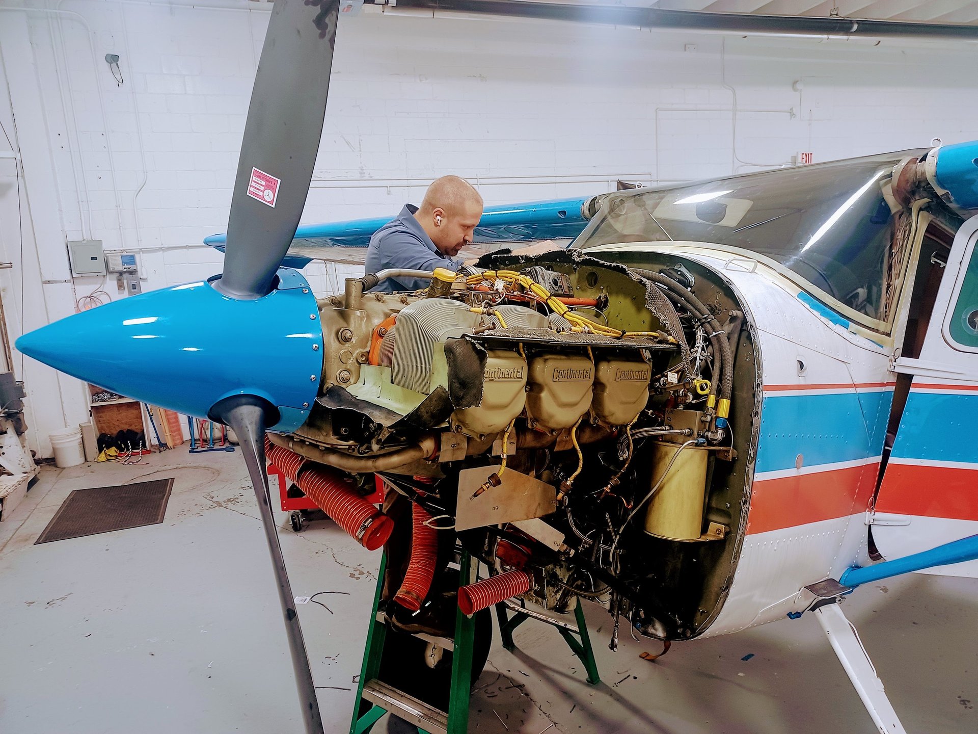 Small airplane with open door on tarmac