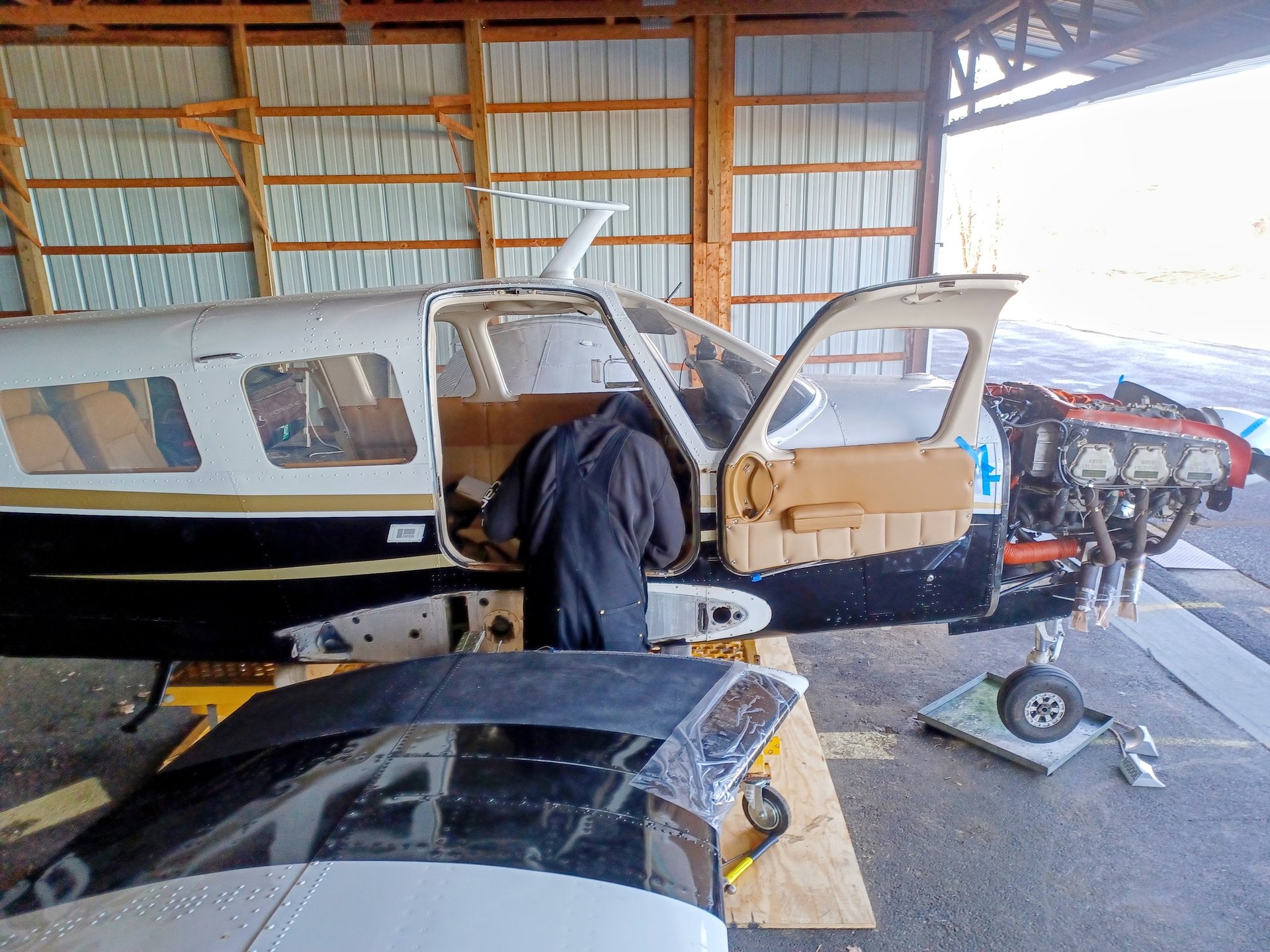 Small airplane with open door on tarmac