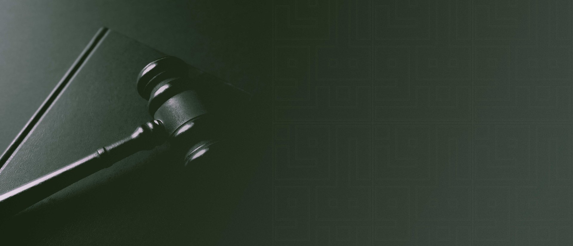 A gavel rests on a dark background.