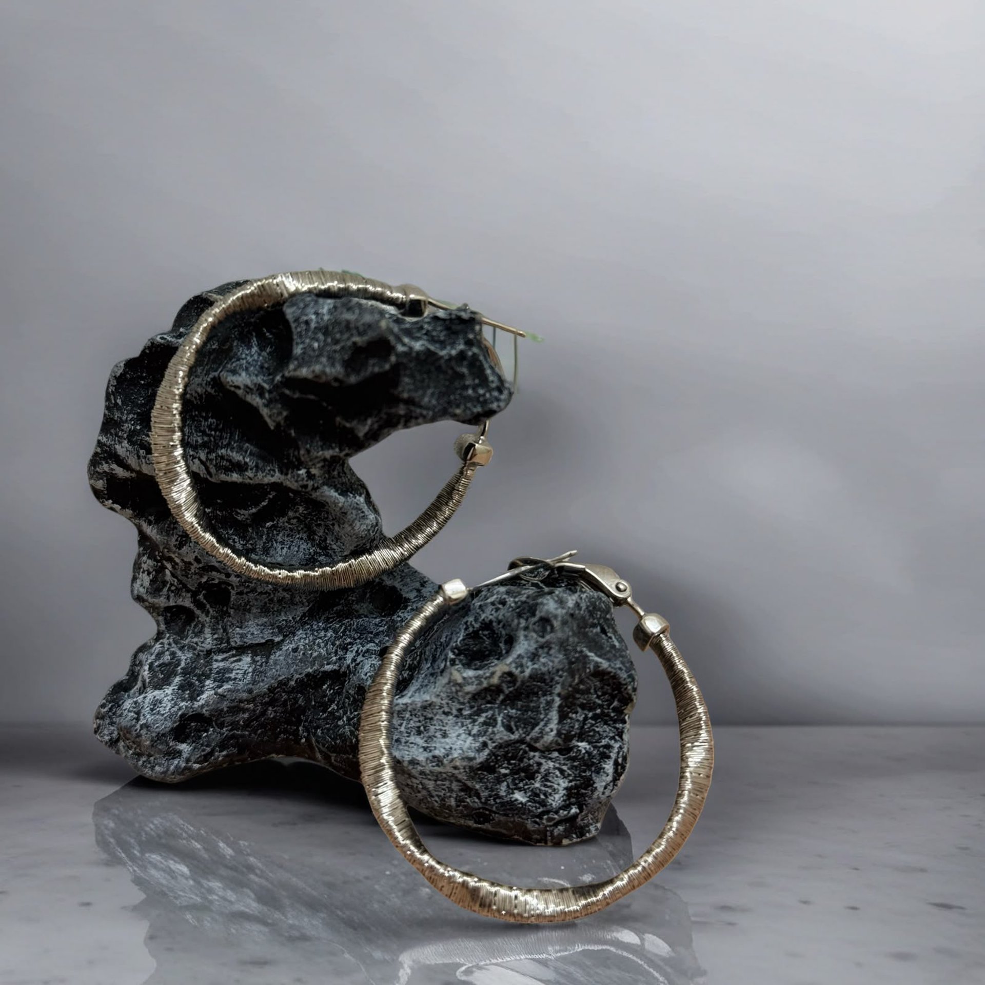 a gold chain bracelet sitting on top of a magazine