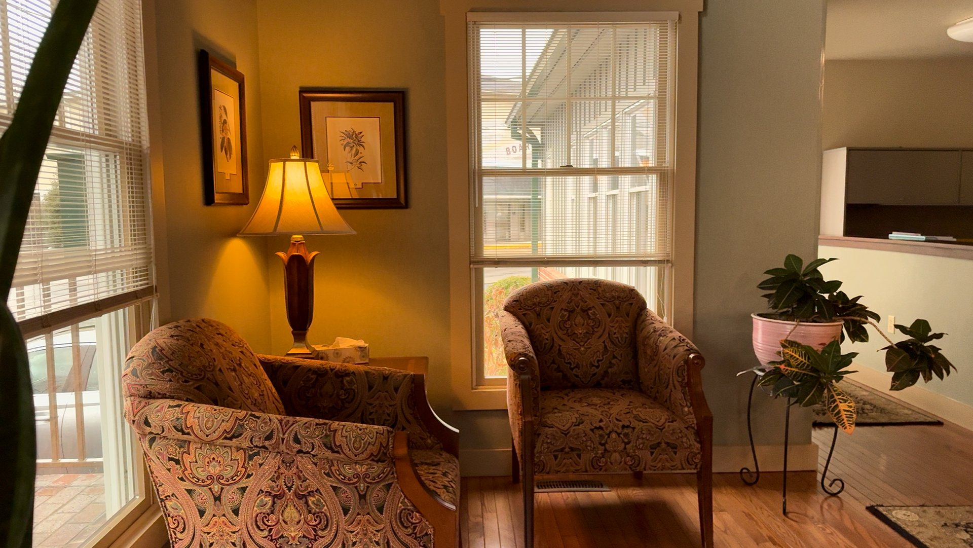 two women sitting beside table and talking