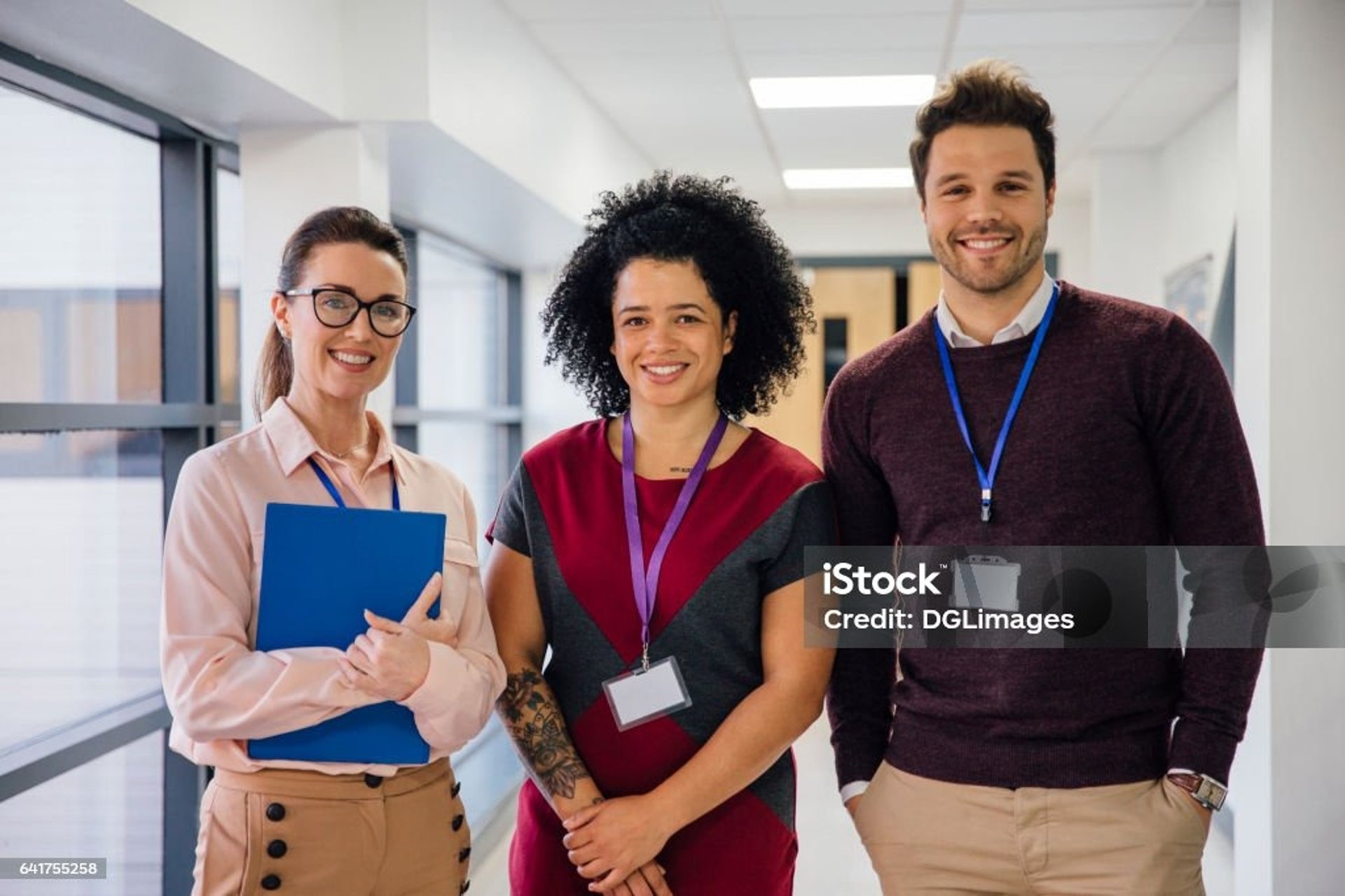 four boy playing ball on green grass
