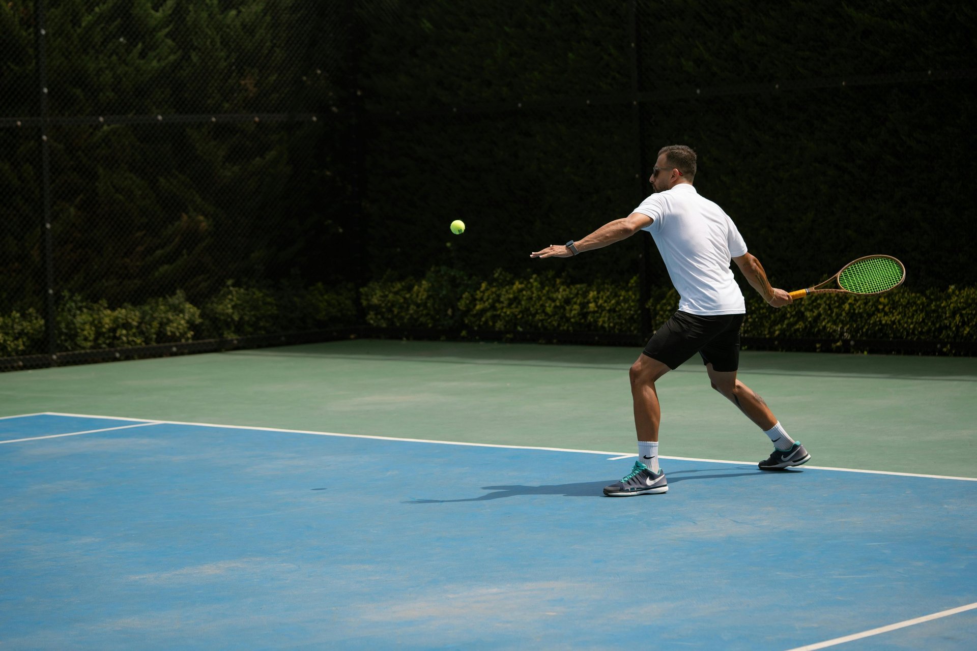 a woman holding a tennis racquet on a tennis court
