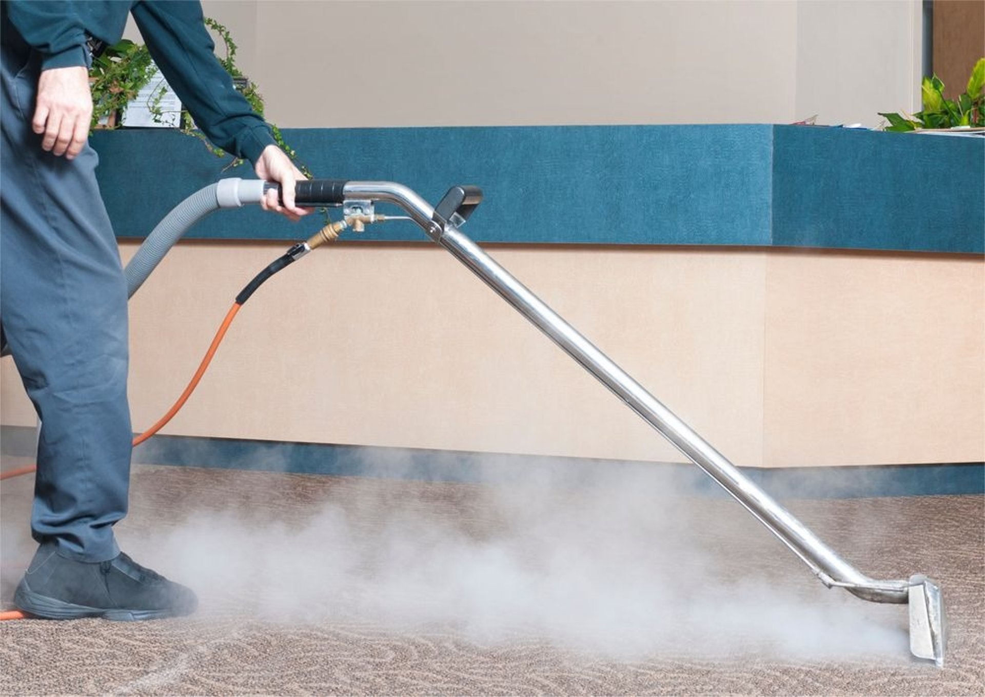 A man sanding a wooden table with a sander