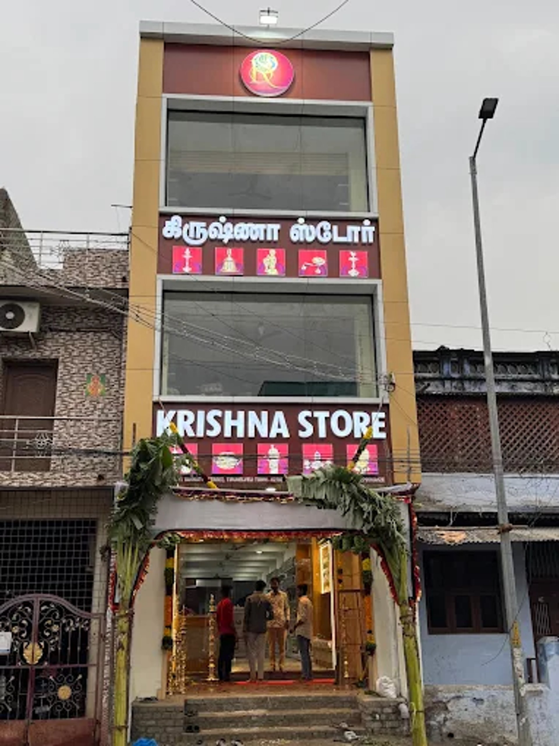 Gilded bronze statue of a seated figure with raised hand.