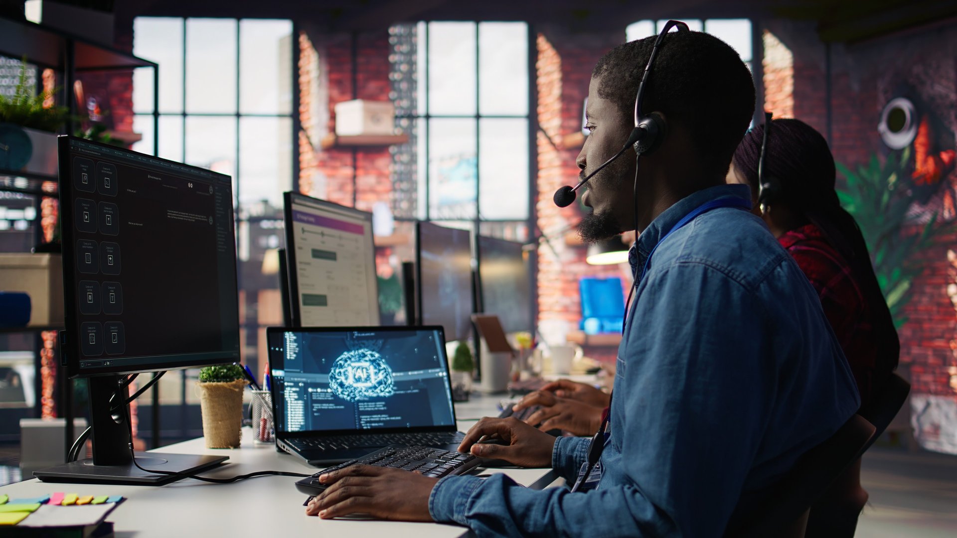 woman in black headphones holding black and silver headphones