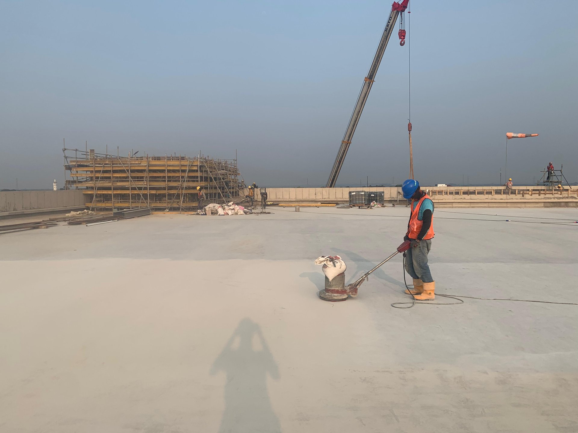 A large room with lots of windows and a ceiling fan