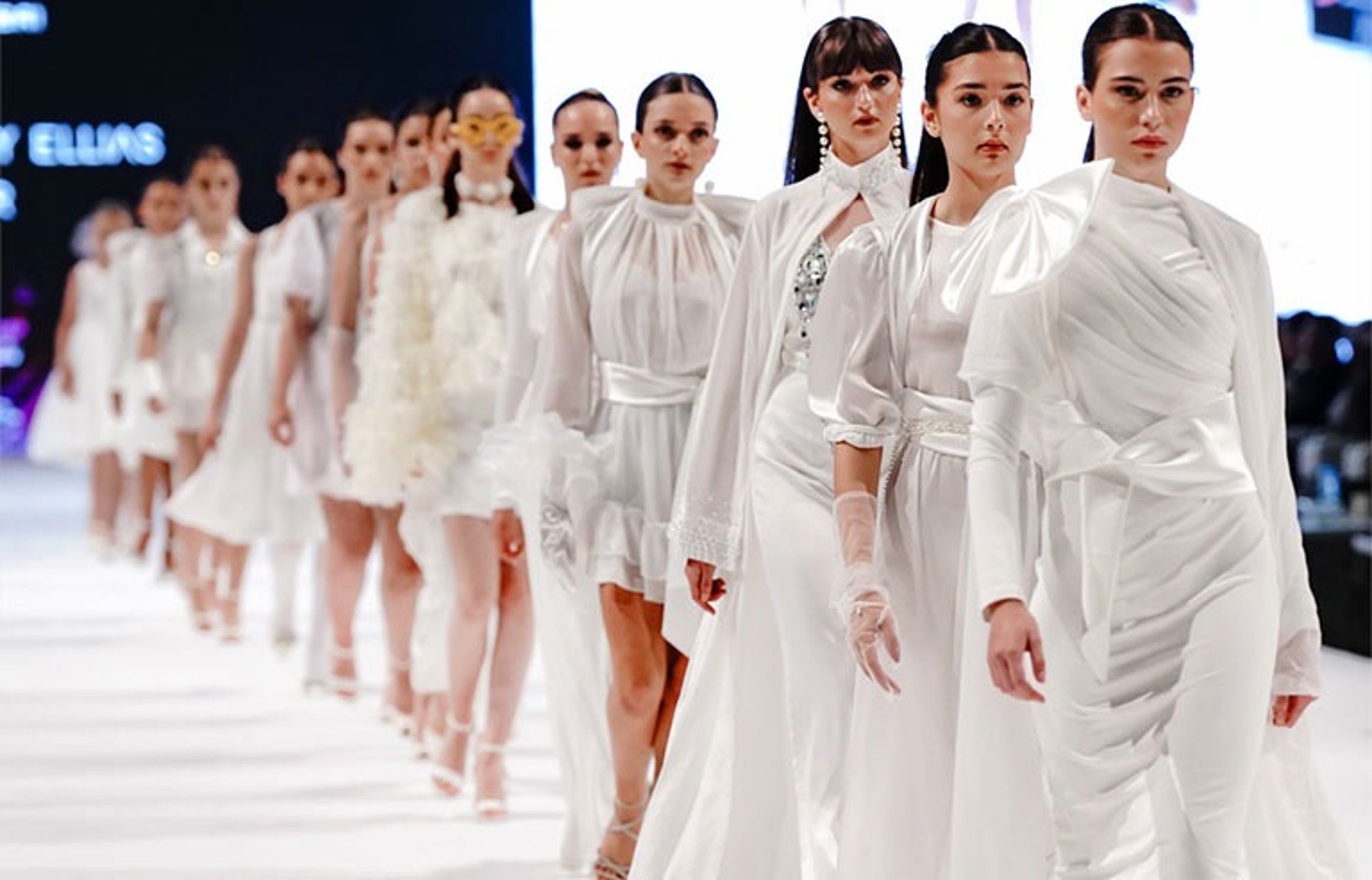 woman wearing yellow long-sleeved dress under white clouds and blue sky during daytime
