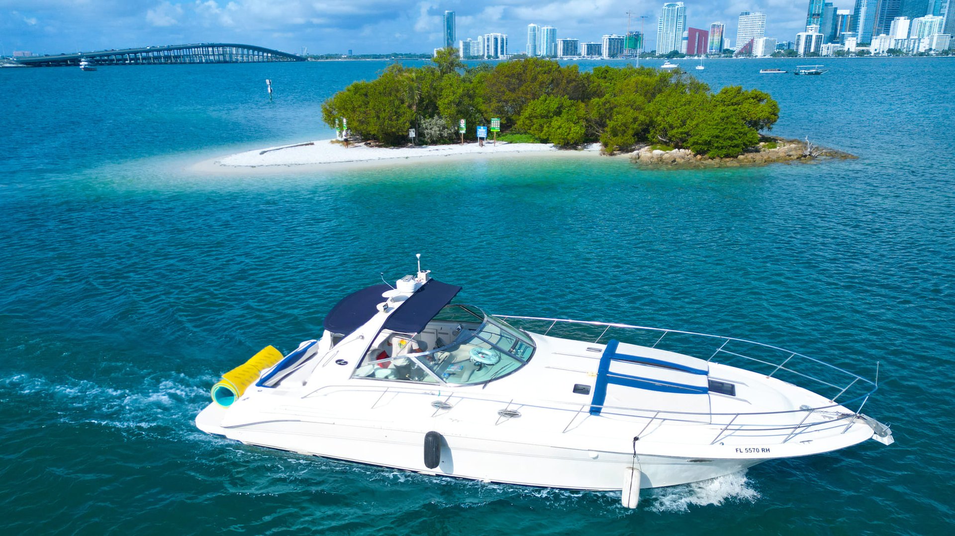 44FT Sea Ray boat rental in Miami cruising Biscayne Bay with skyline views