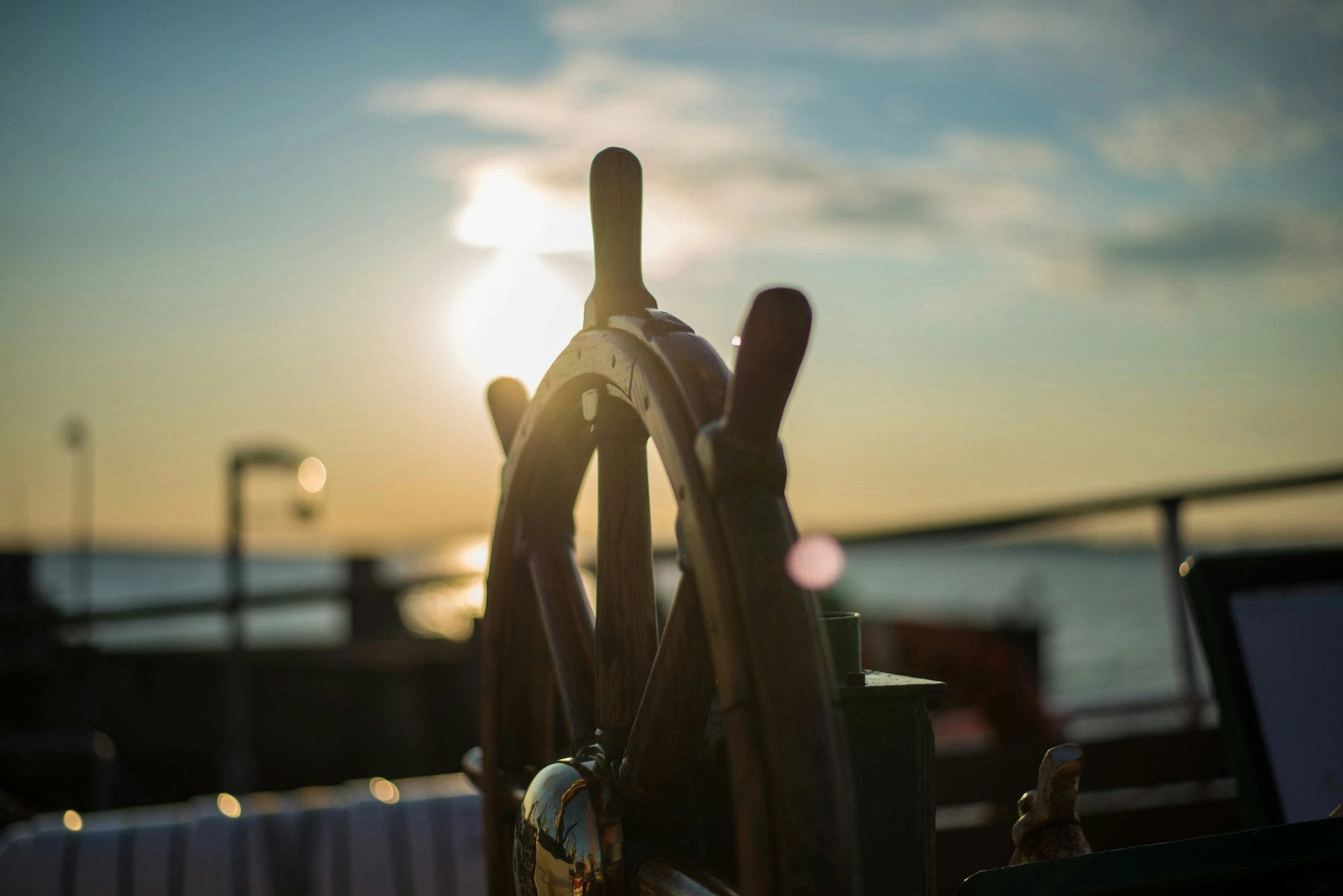 A man sitting on a sailboat in the water