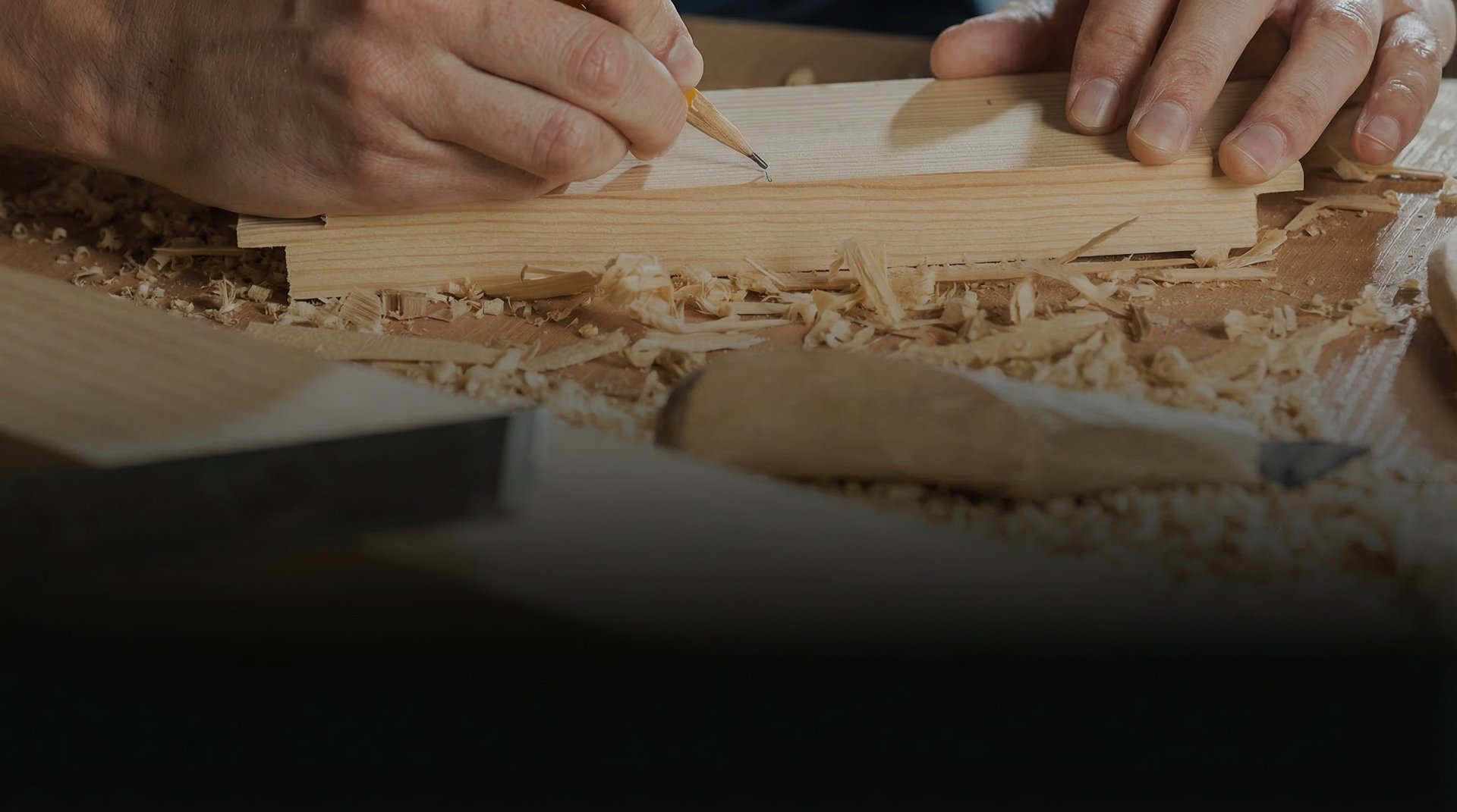 a person cutting a piece of wood