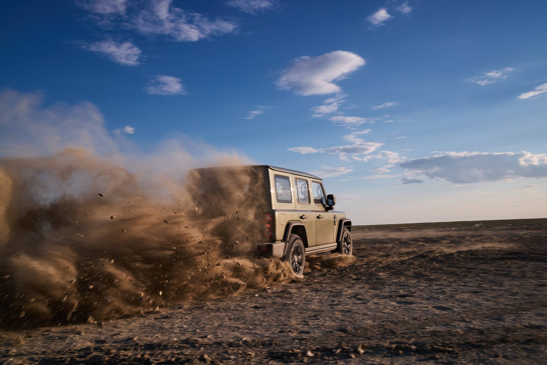 woman wearing yellow long-sleeved dress under white clouds and blue sky during daytime