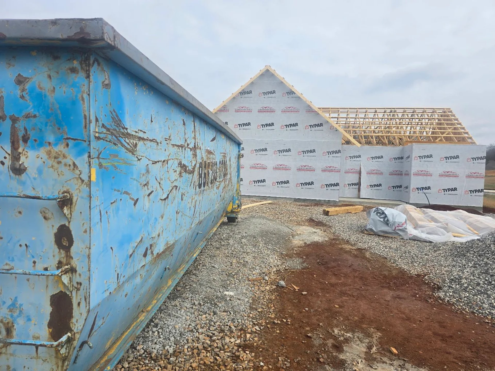 a bulldozer is parked in front of a house
