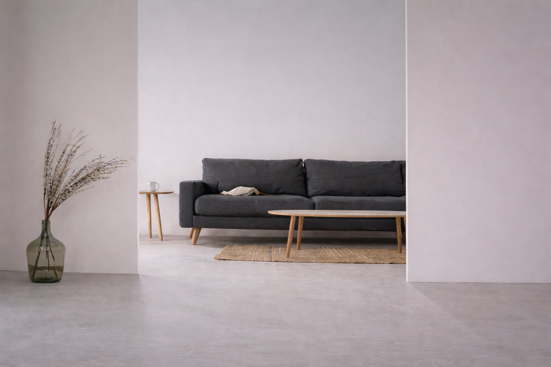 a long bench in a large room with a plant in the corner