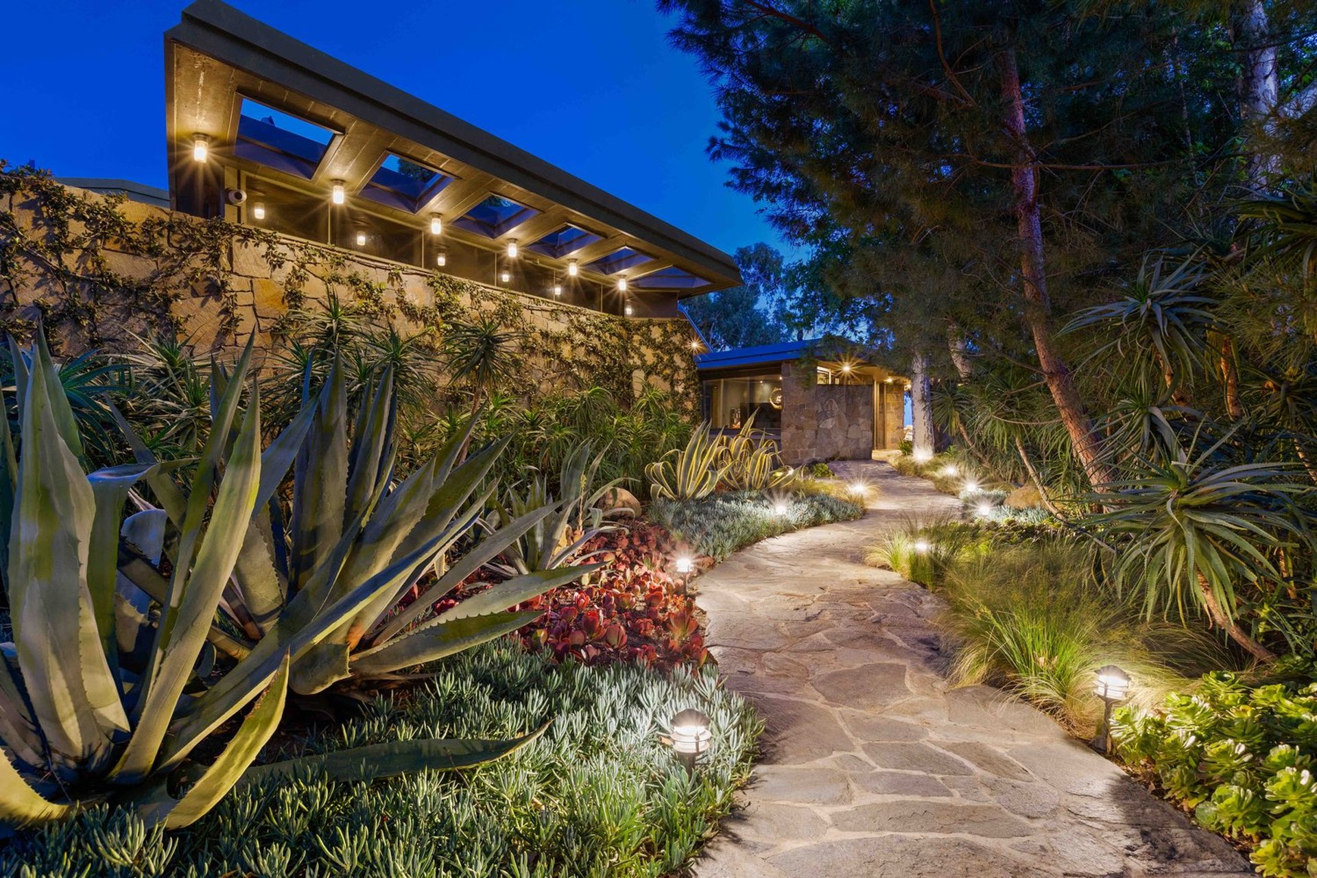 an abstract photo of a curved building with a blue sky in the background