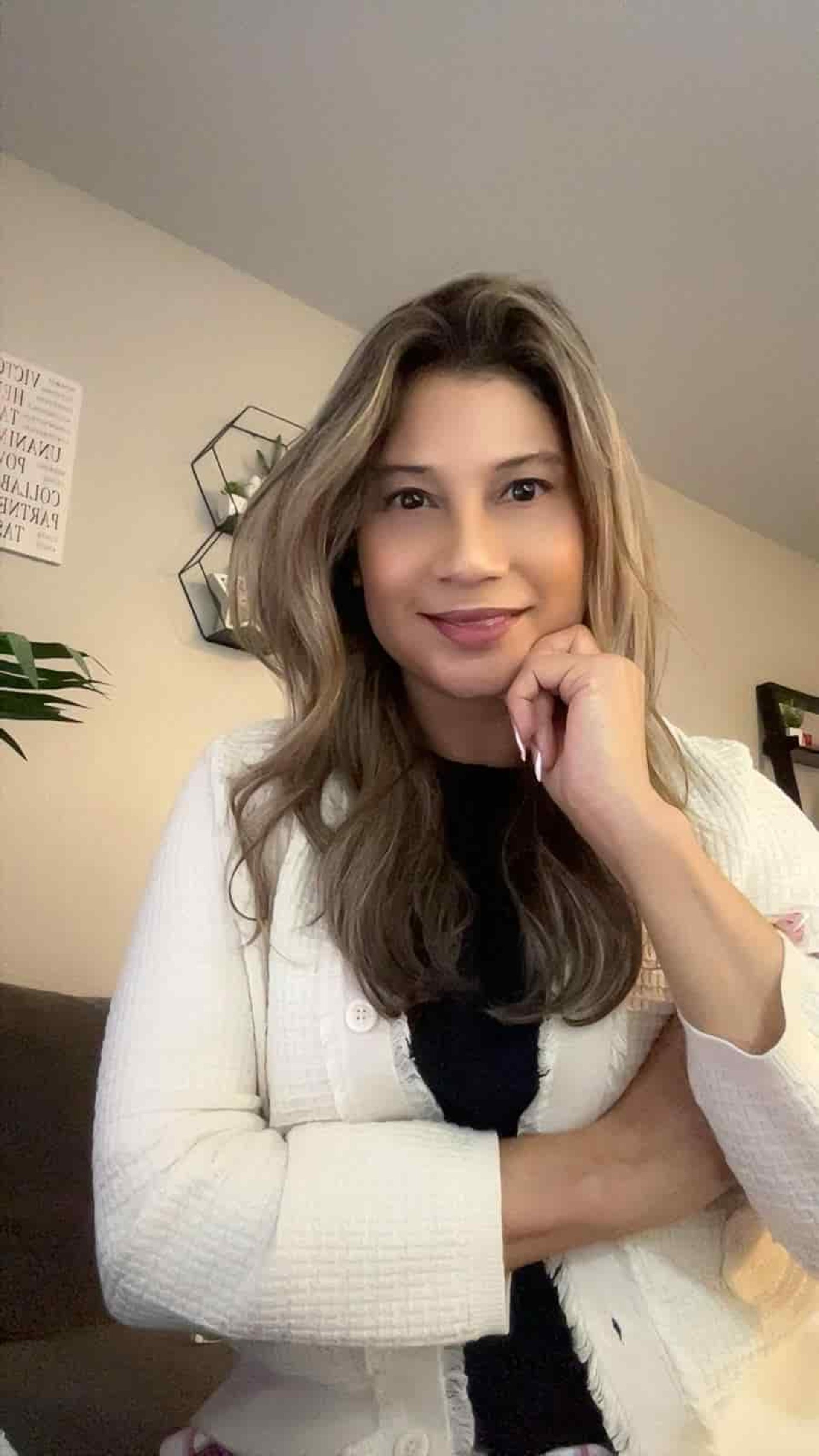 woman signing on white printer paper beside woman about to touch the documents