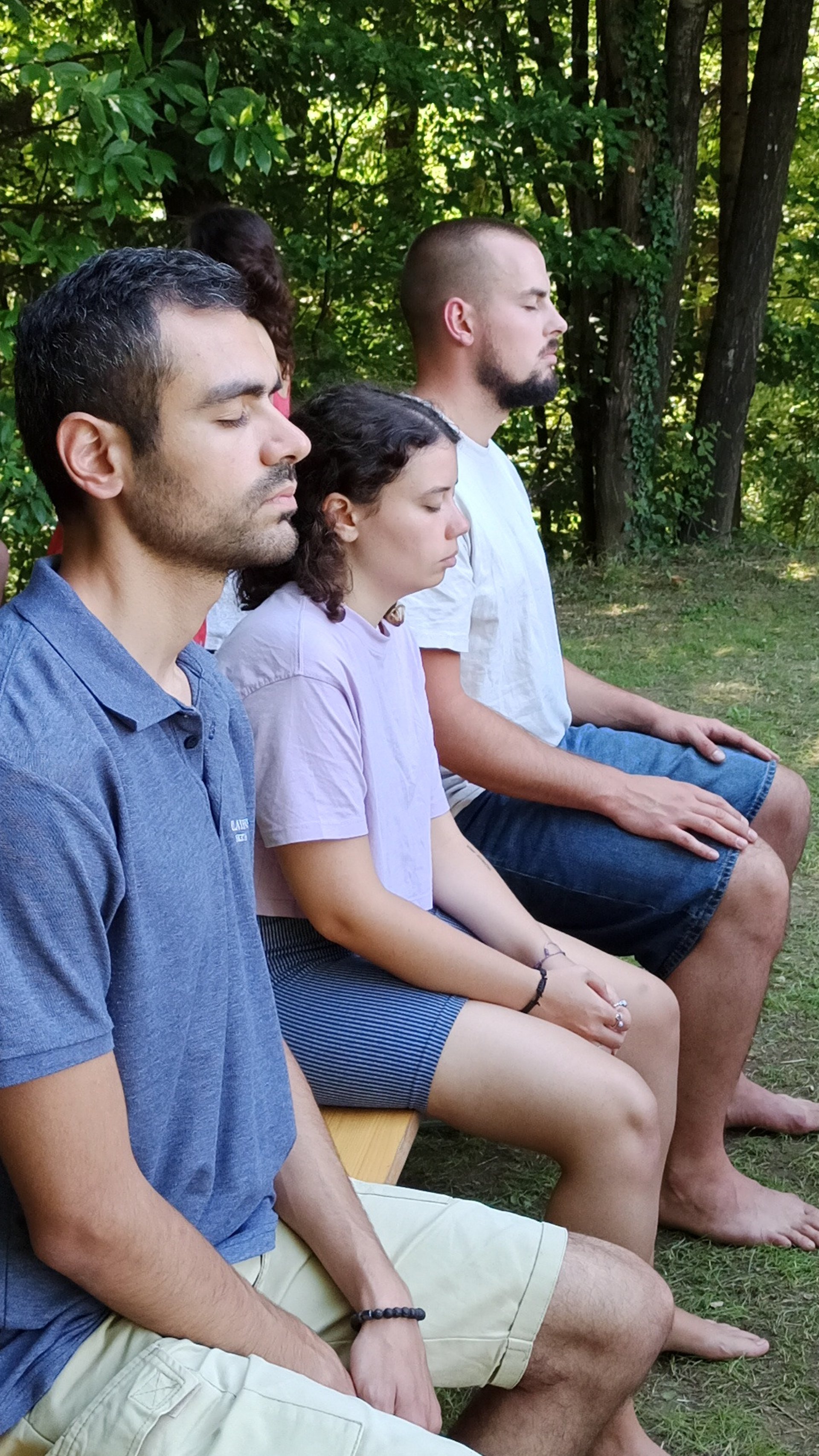 a man sitting on a bench holding a cup of coffee