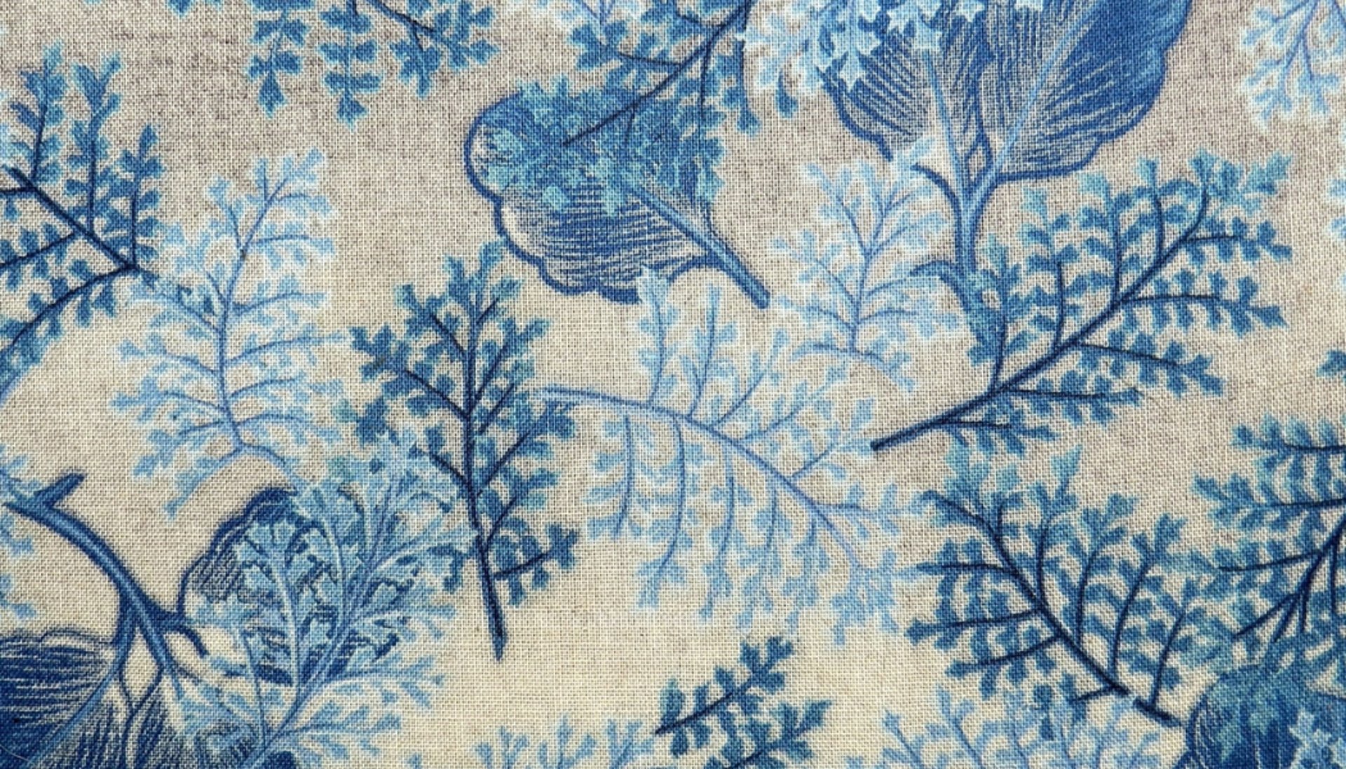 person leaning on wall while holding gray hat