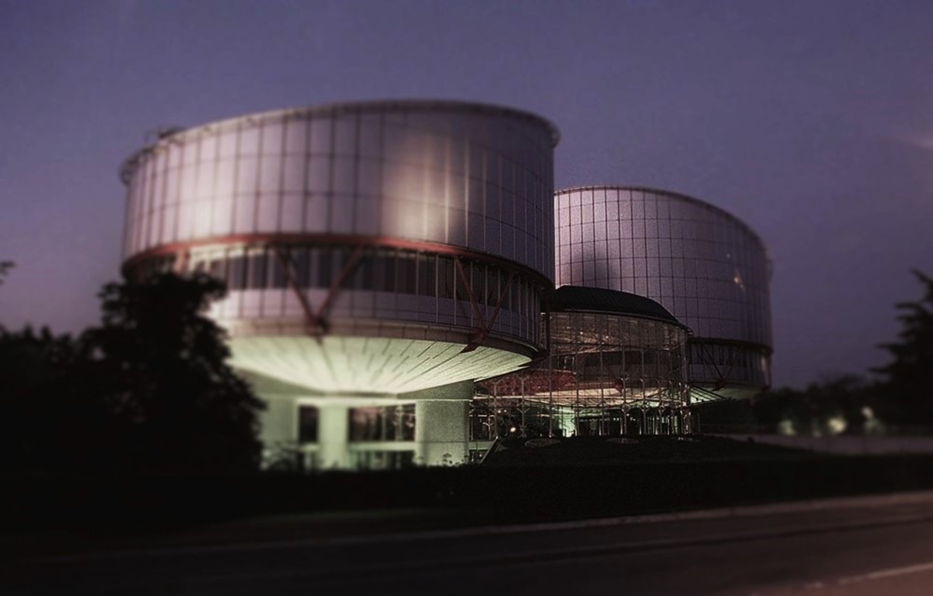 an abstract photo of a curved building with a blue sky in the background