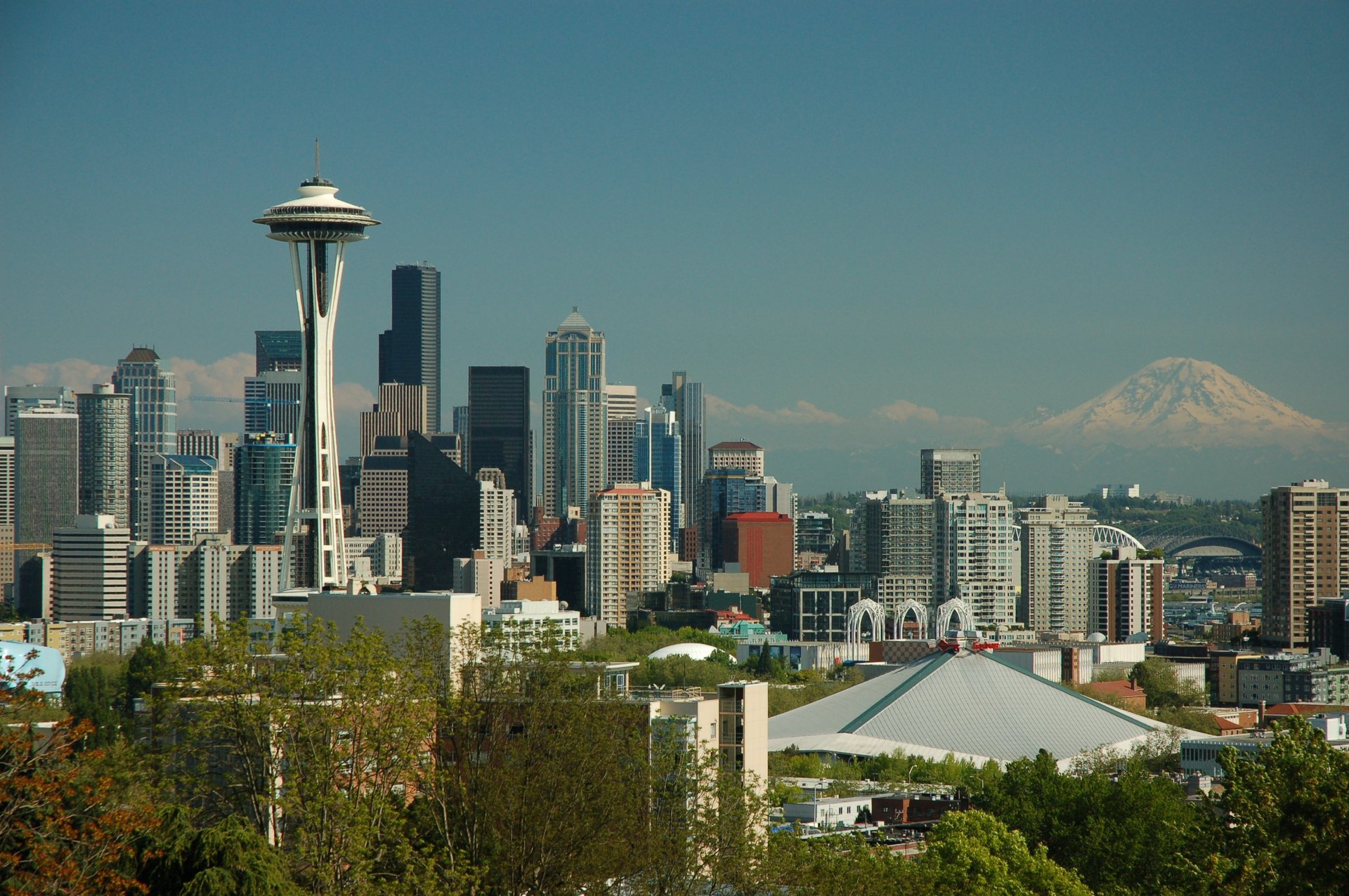 two brown houses surrounded by trees during daytime