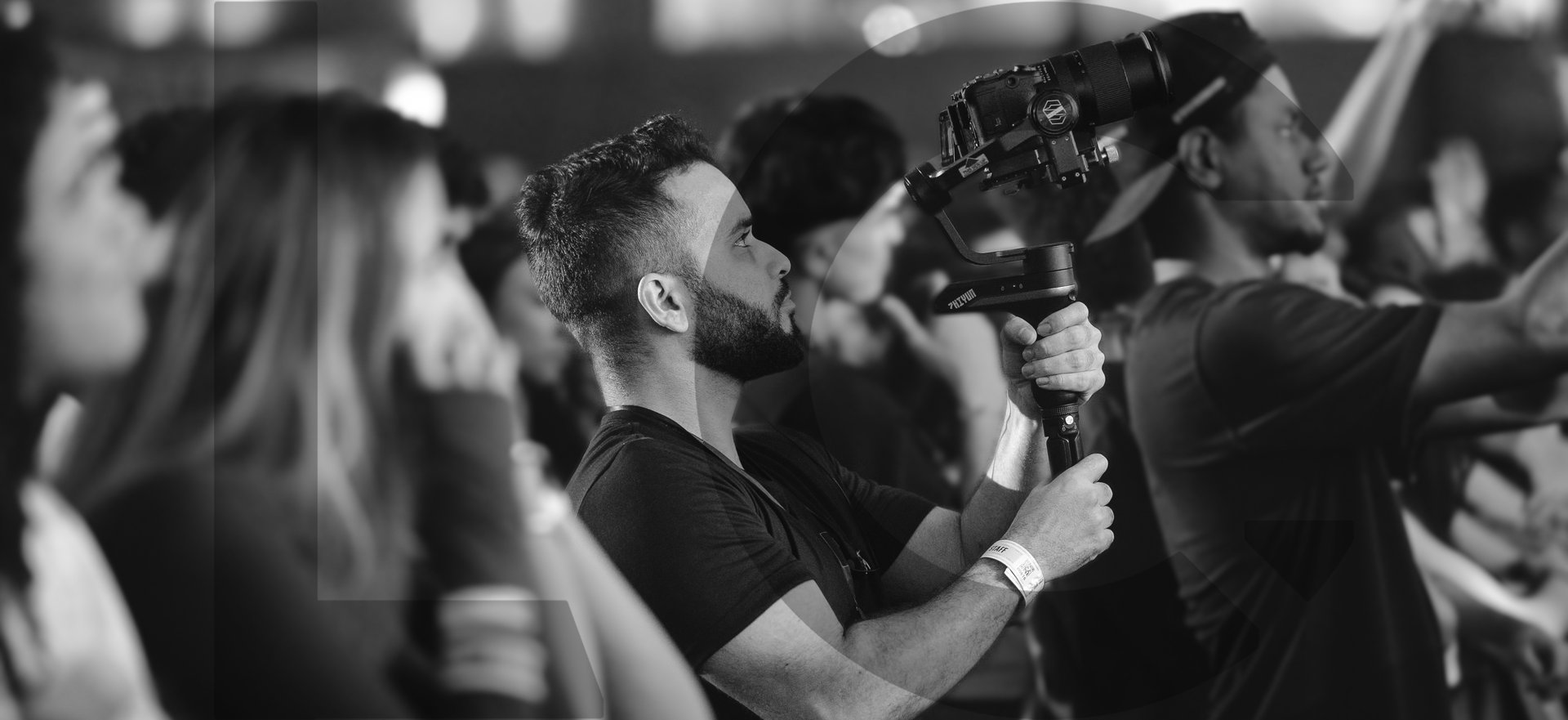 man in black and red long sleeve shirt holding black video camera