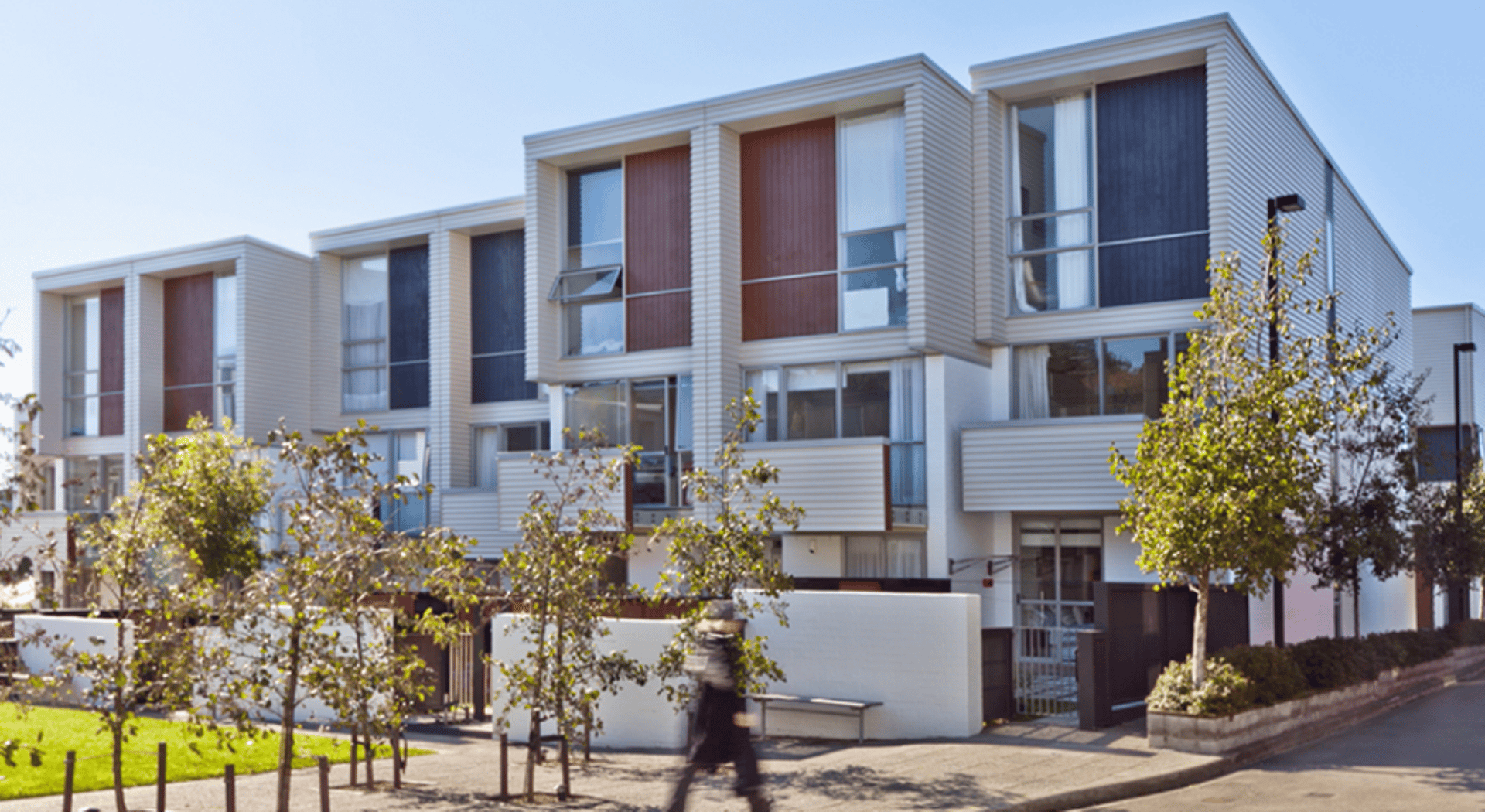 an abstract photo of a curved building with a blue sky in the background
