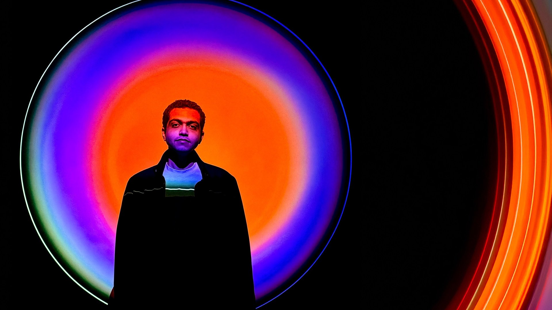 an abstract photo of a curved building with a blue sky in the background