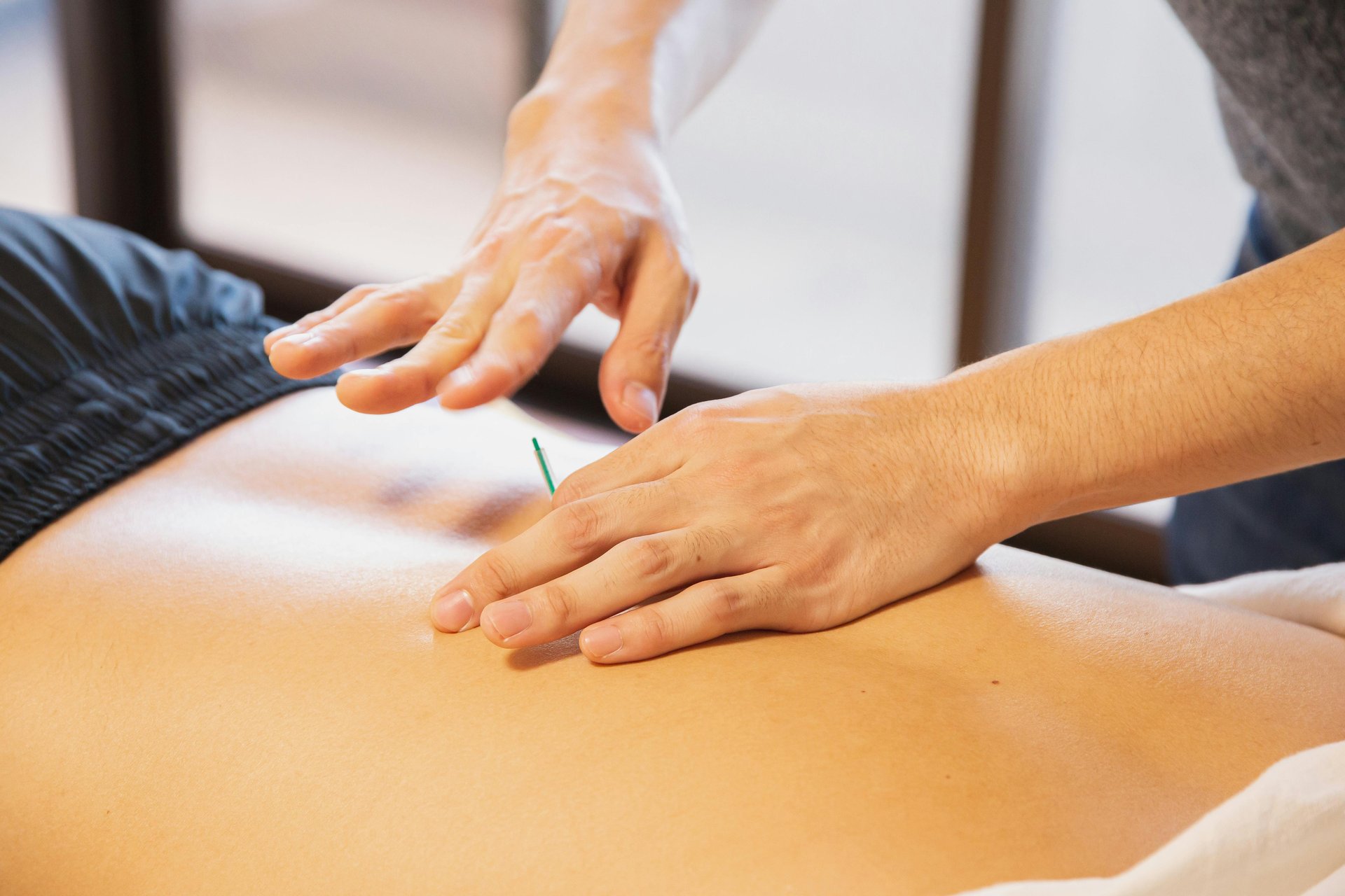 a man getting a back massage from a woman