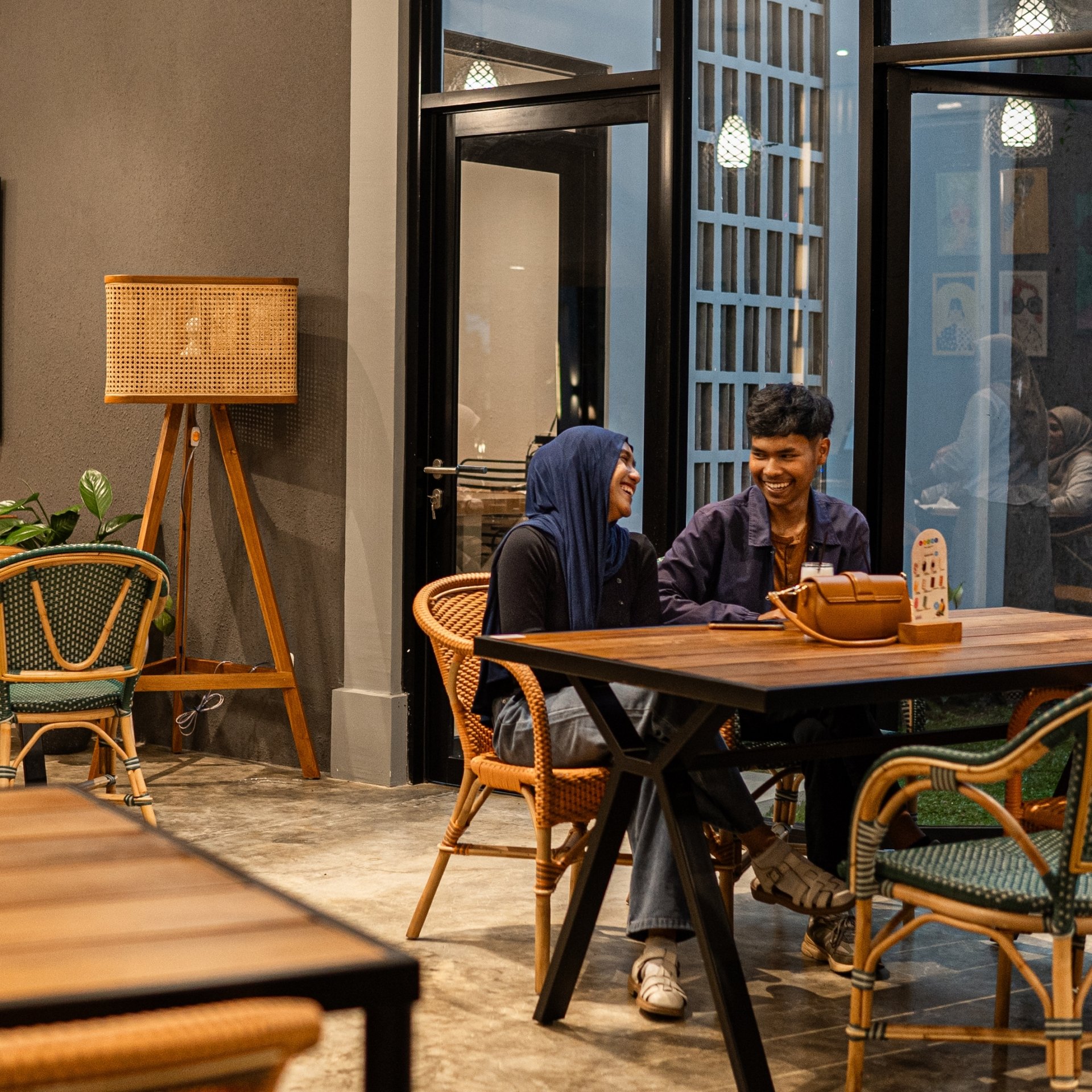 a restaurant with wooden tables and chairs