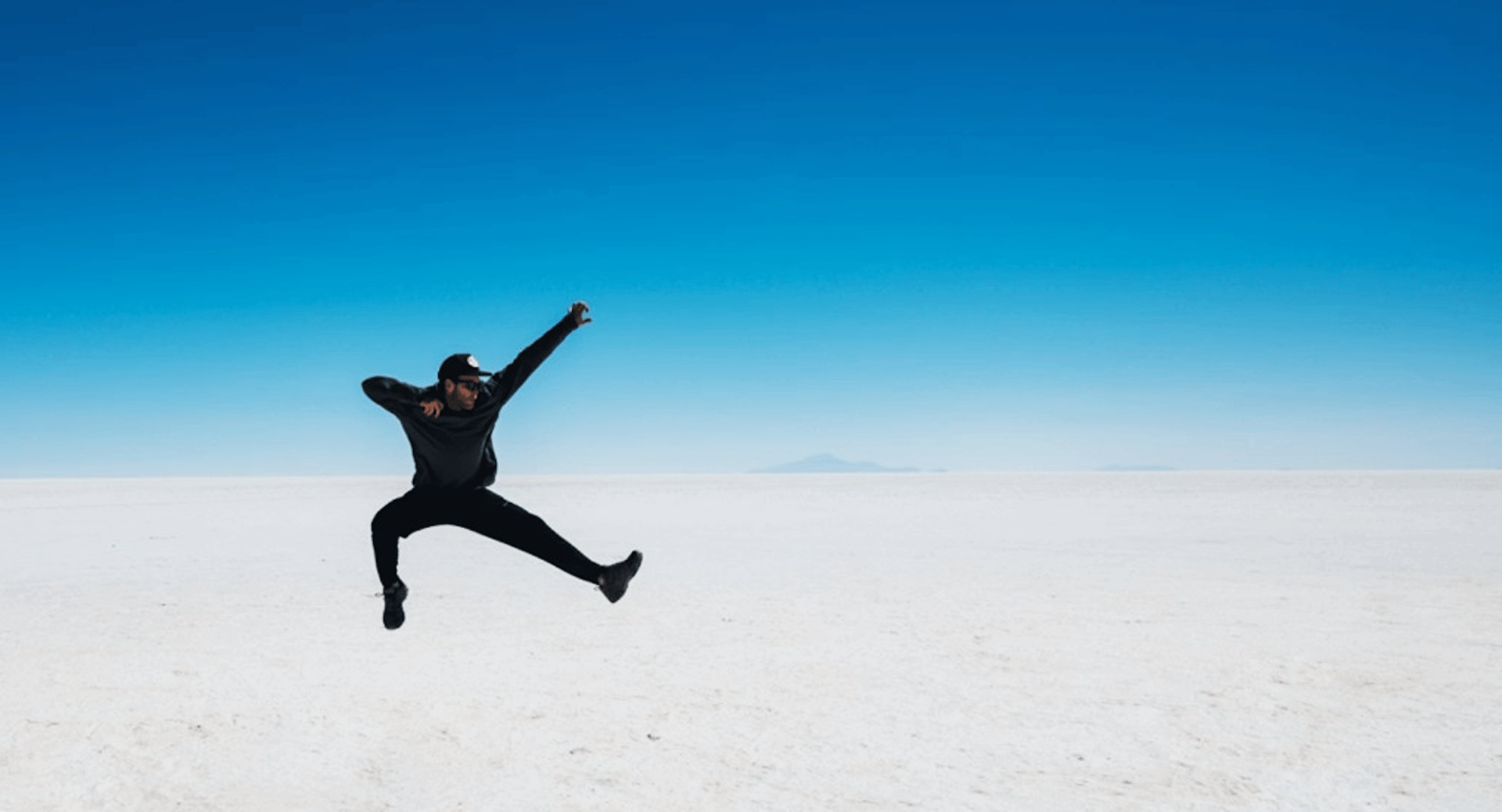 man jumping on desert