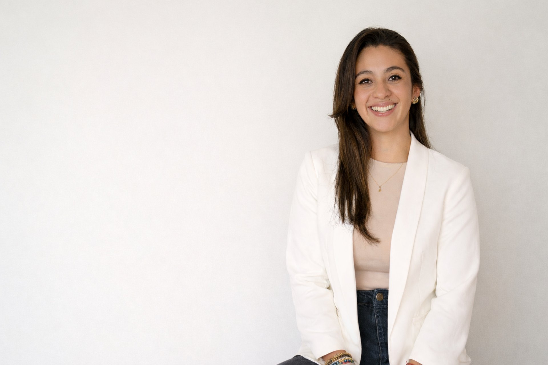 girl wearing grey long-sleeved shirt using MacBook Pro on brown wooden table