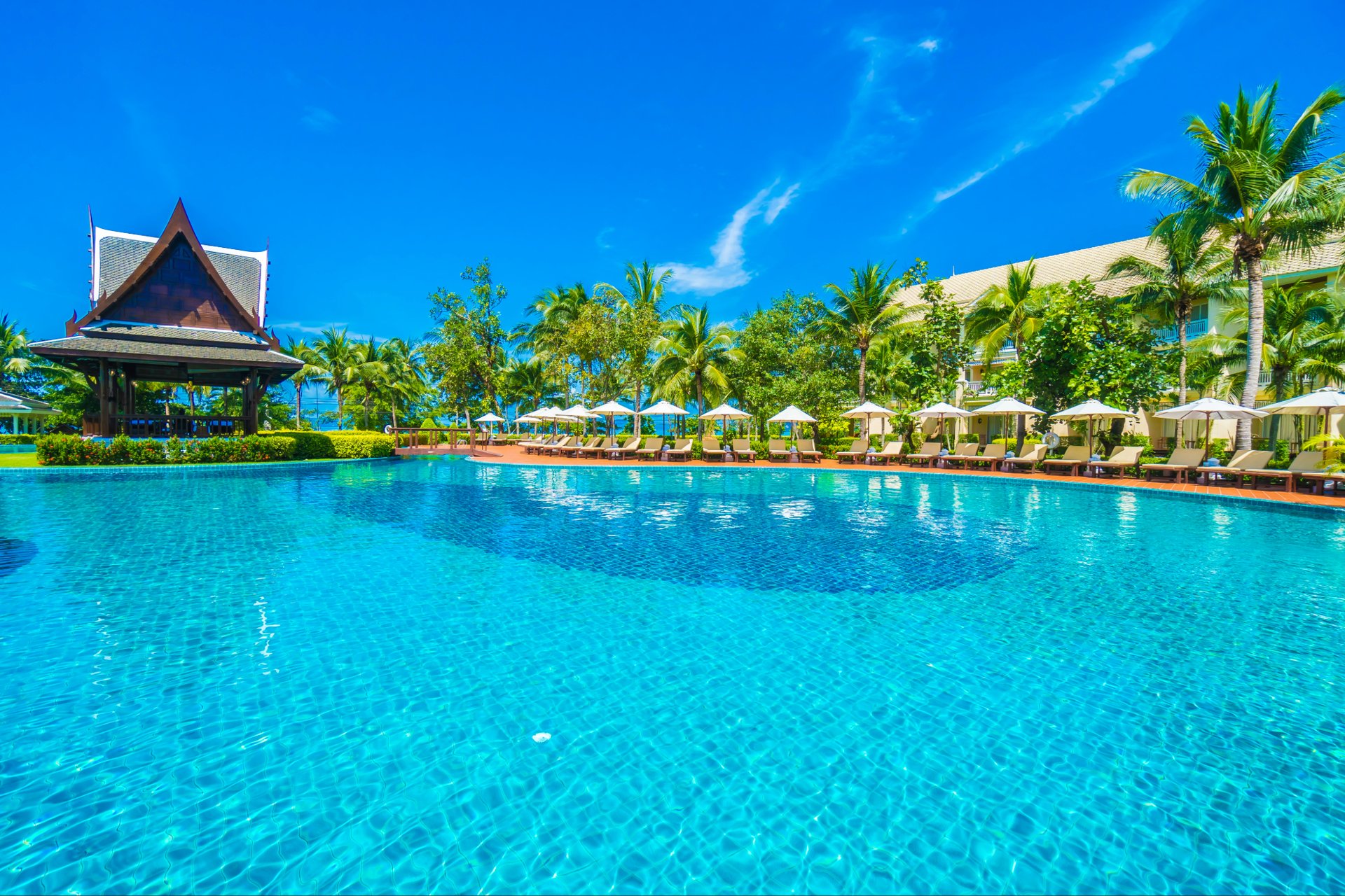 Resort pool with chairs and beach bar