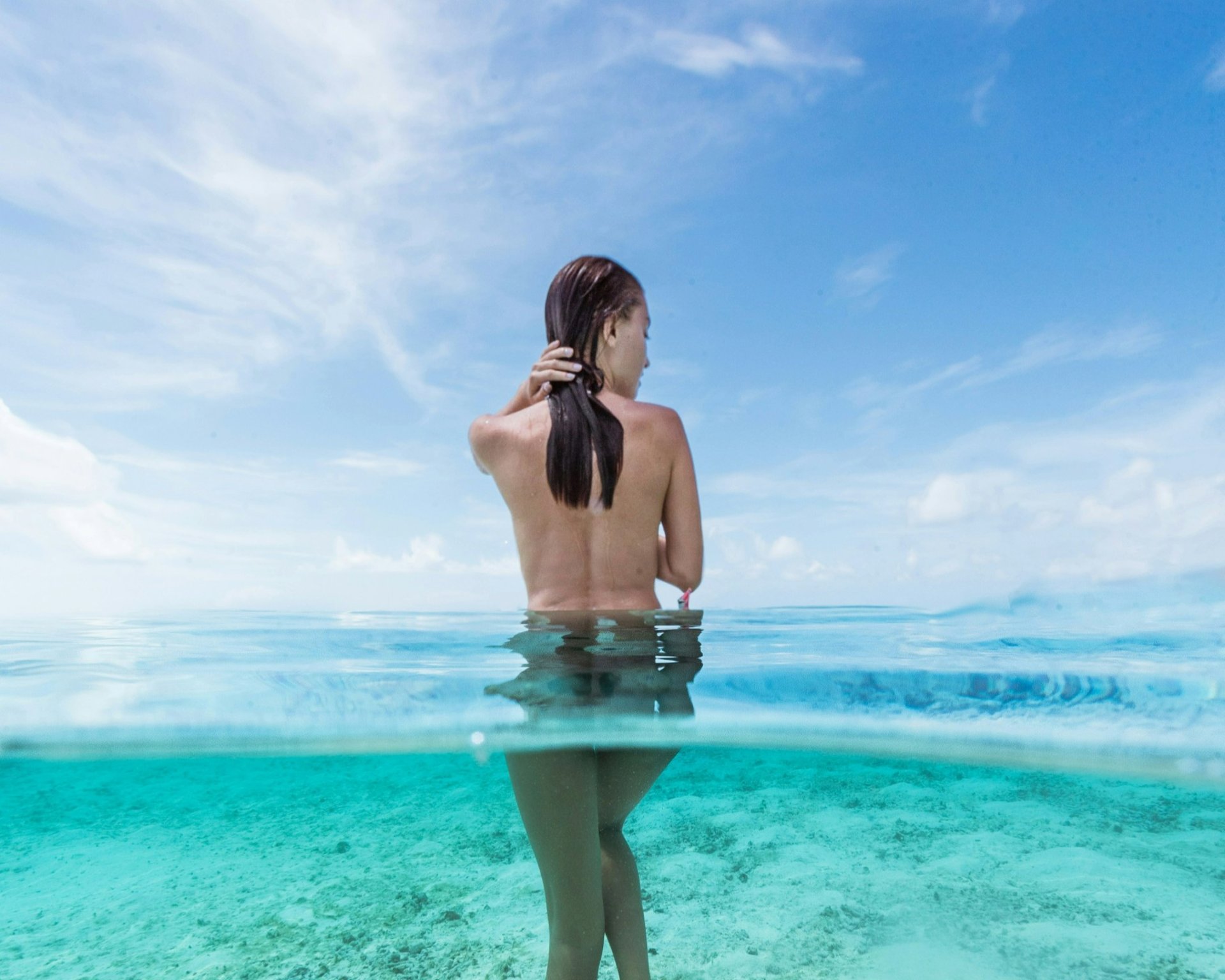 Woman walking in ocean