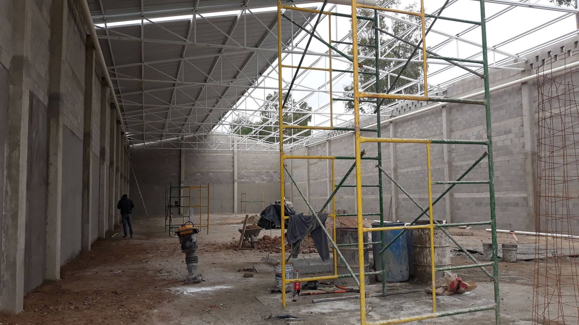 a man on a scaffold working on a building
