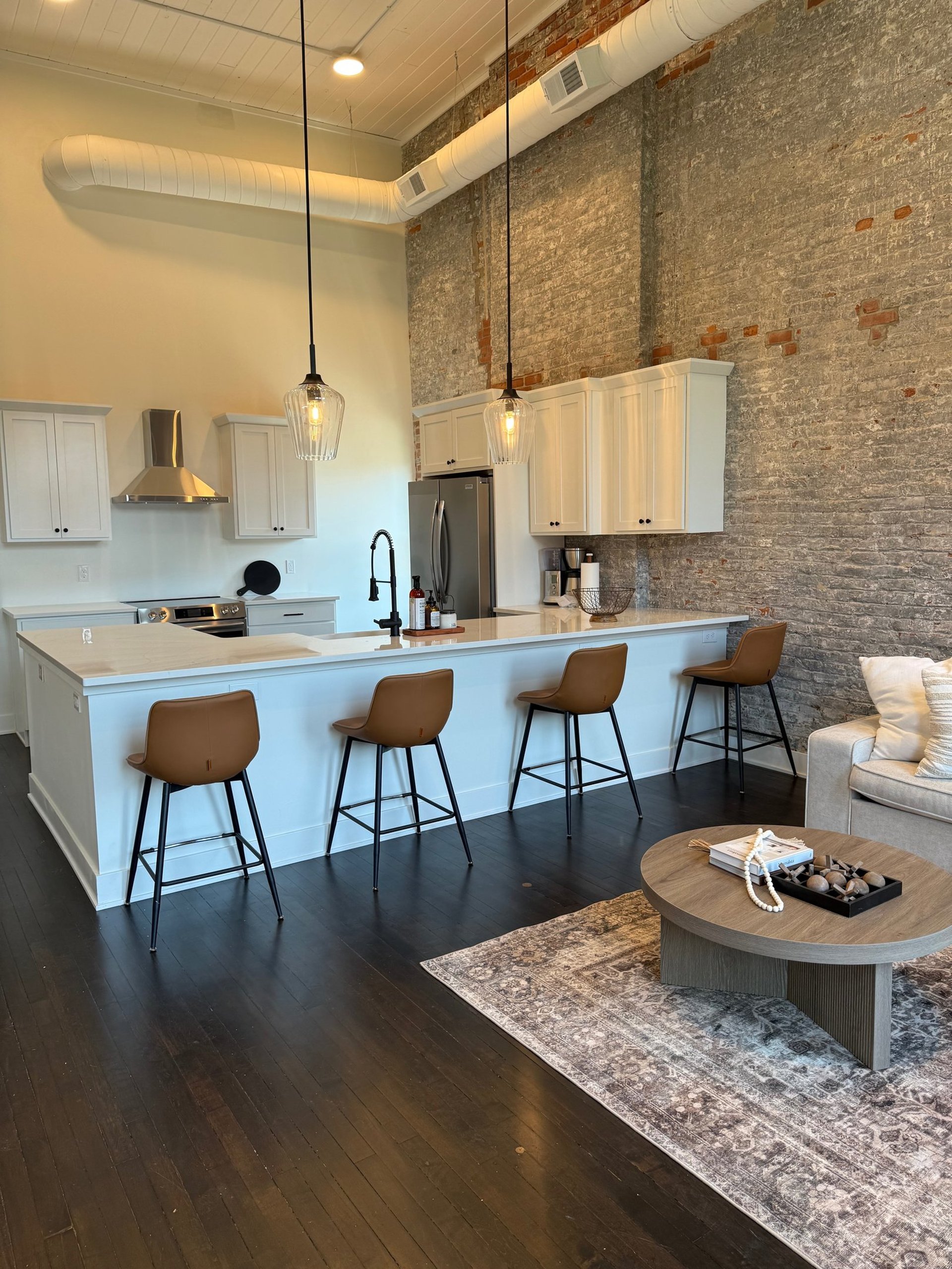 black and brown leather padded tub sofa