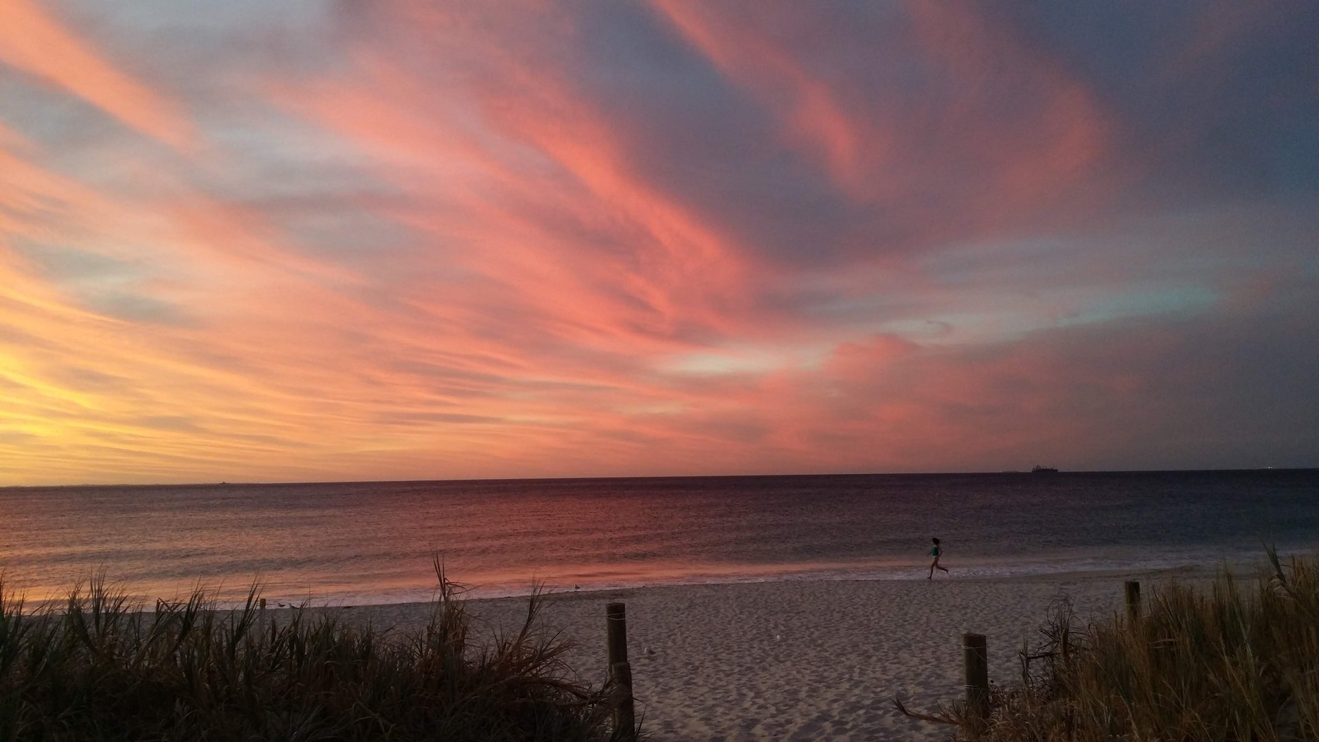 woman wearing yellow long-sleeved dress under white clouds and blue sky during daytime