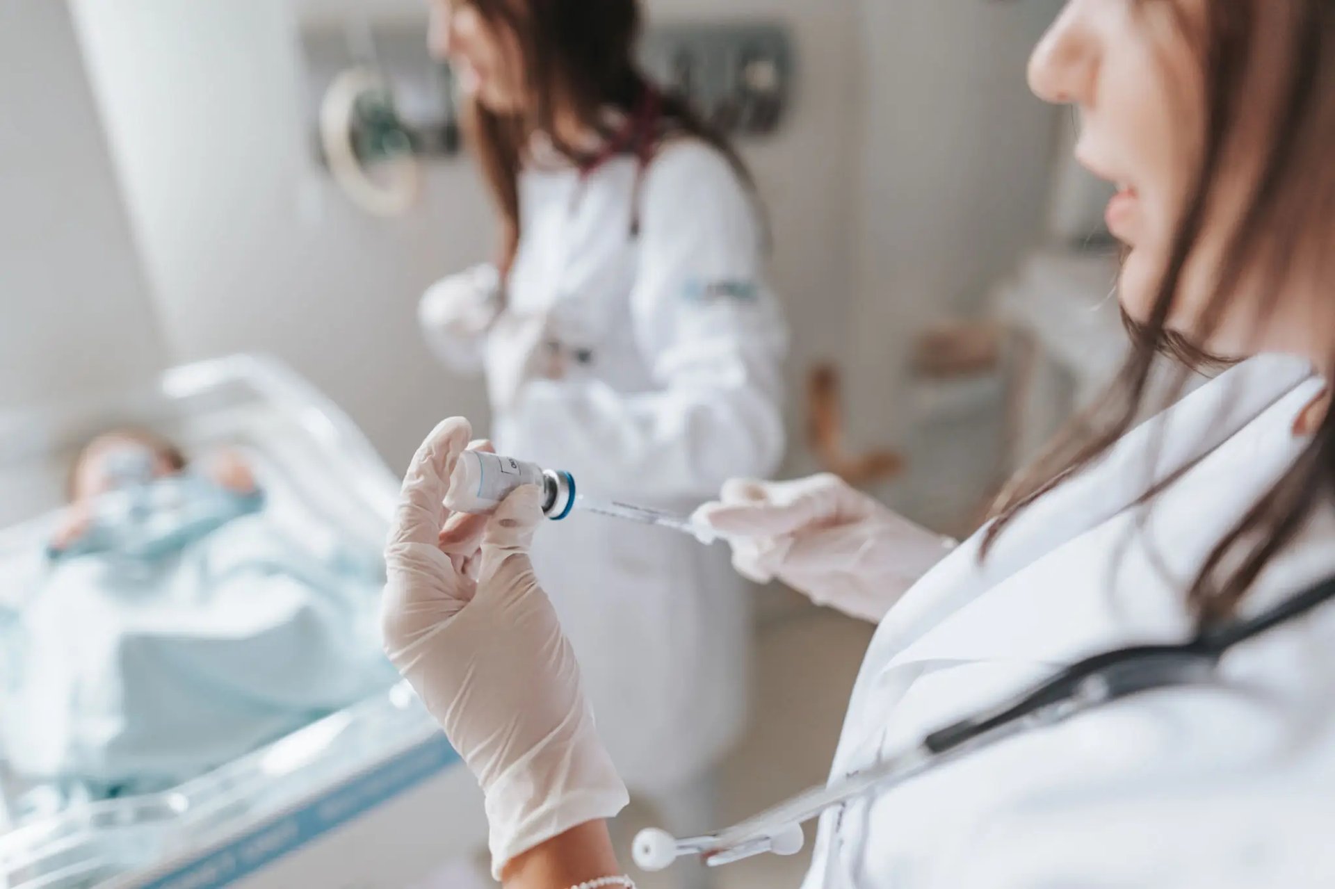 woman in white long sleeve shirt covering face with hand