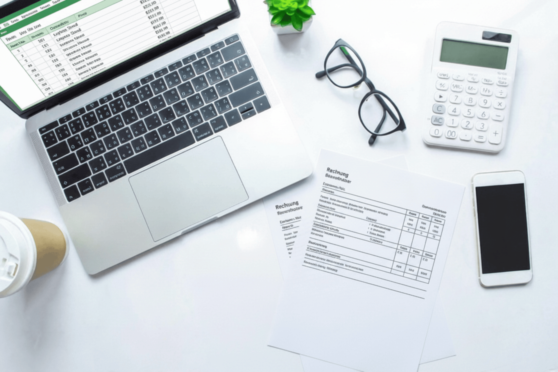 a calculator sitting on top of a table next to a laptop