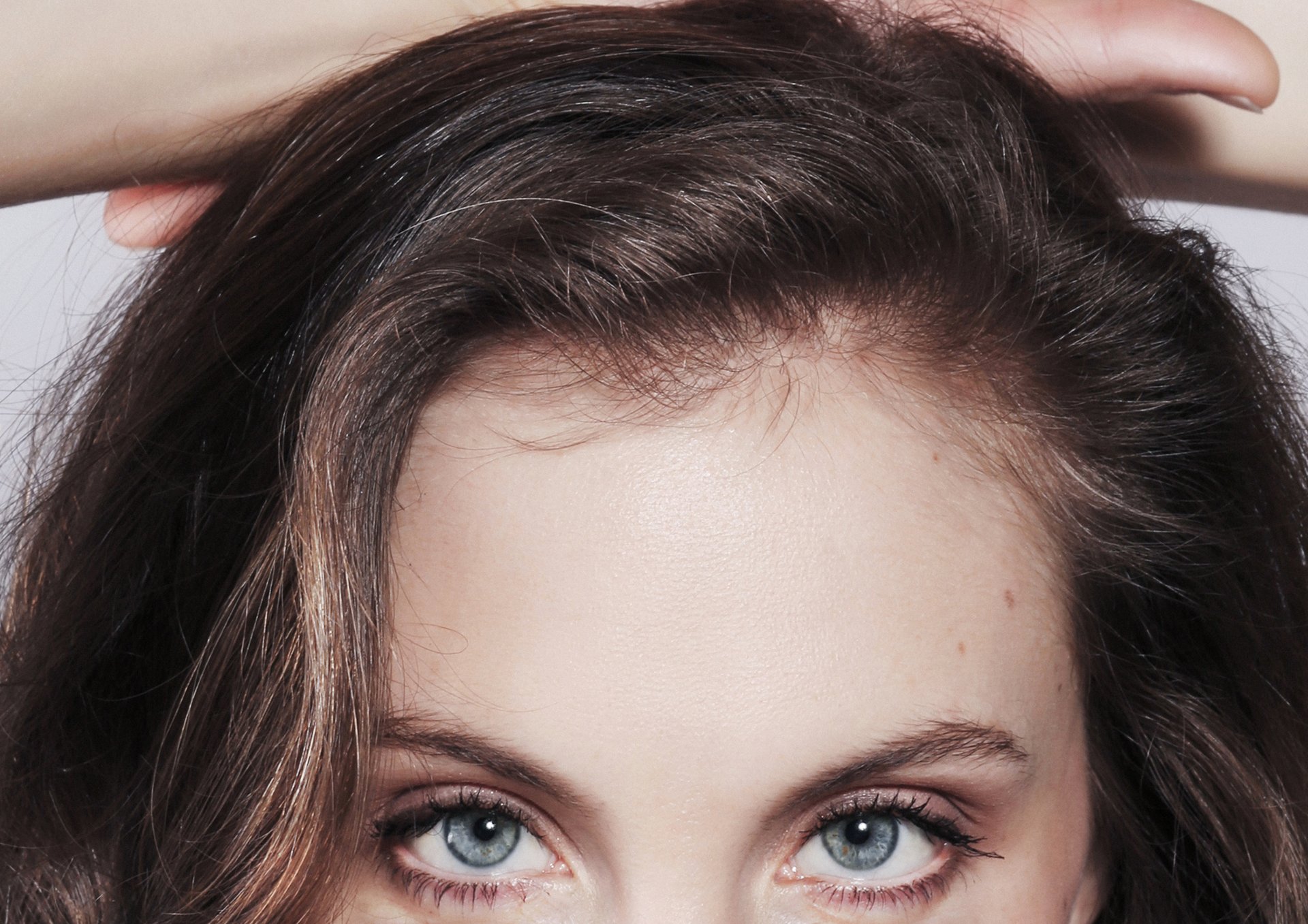 an abstract photo of a curved building with a blue sky in the background