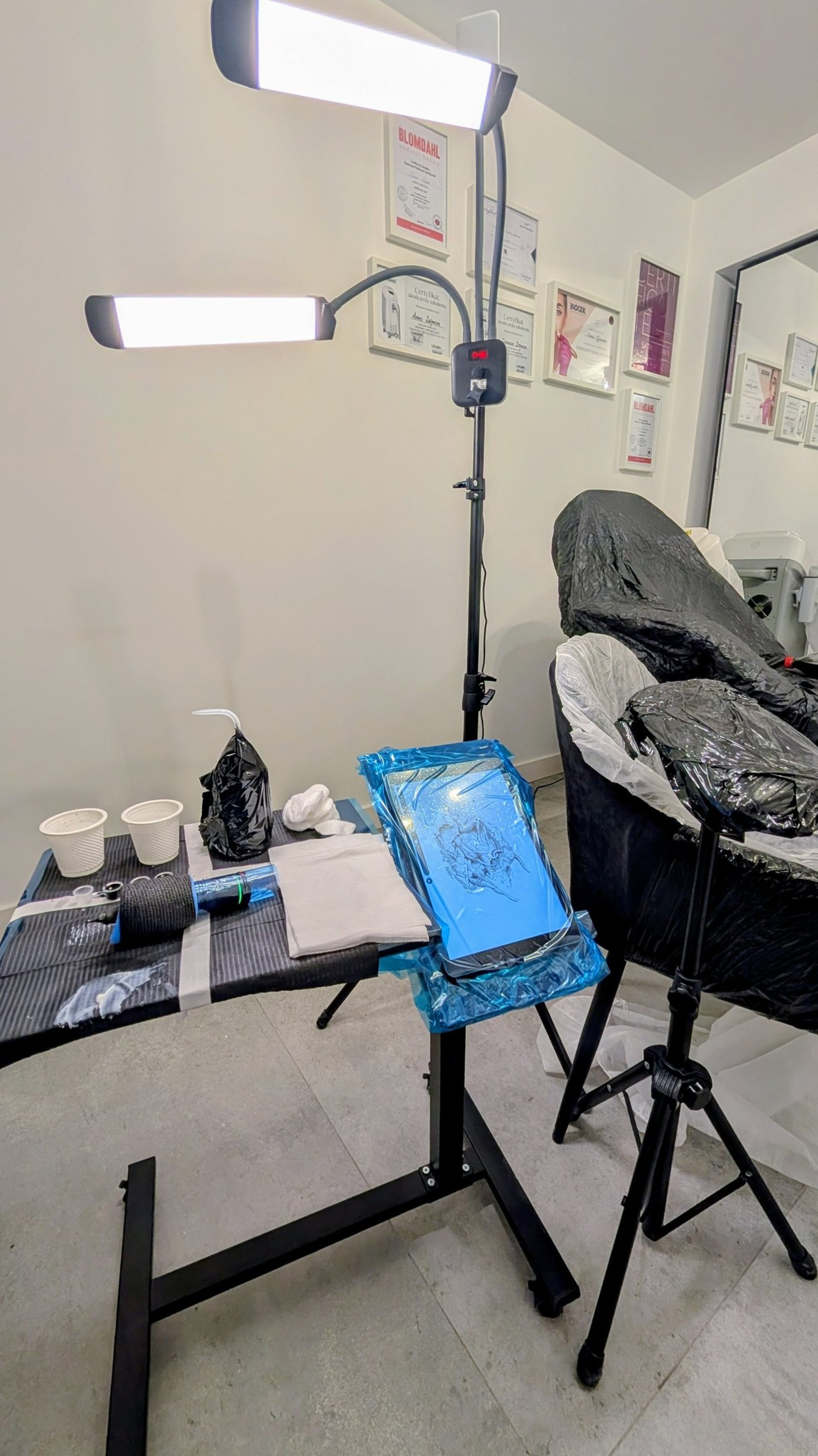 woman lying on blue towel with white cream on face